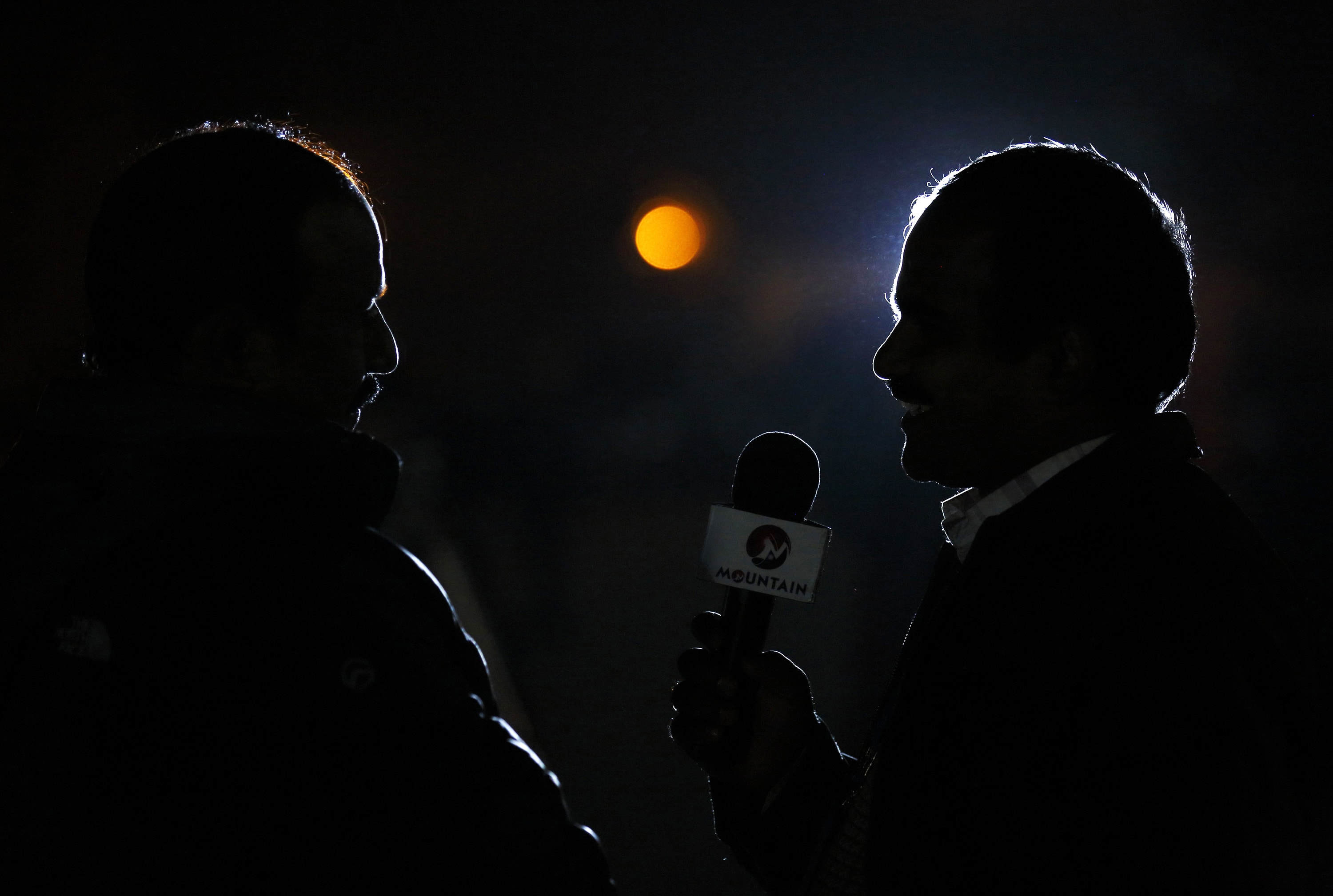 A journalist (R) is silhouetted as he interviews a constitution assembly member outside the parliament in Kathmandu, 22 January 2015 , REUTERS/Navesh Chitrakar