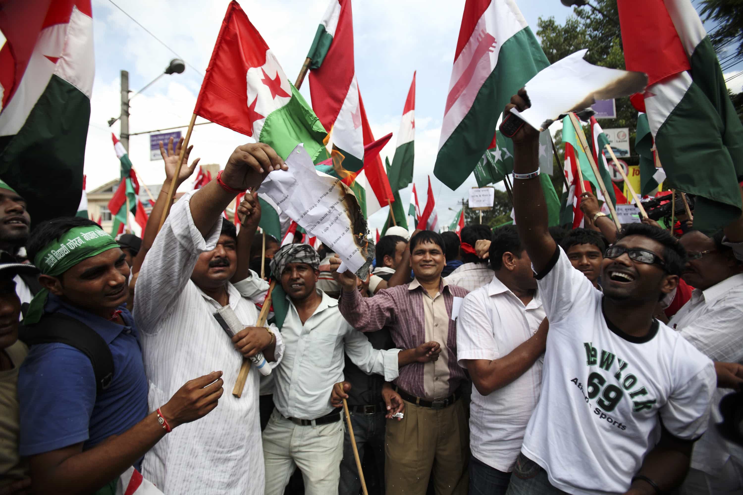 United Democratic Madhesis Front (UDMF) supporters protest in Khatmandu, 26 August 2011, United Democratic Madhesis Front (UDMF) supporters burn a copy of the Supreme Court order on the national dress in Kathmandu August 26, 2011. The Supreme Court of Nepal upheld a government decision to declare daura-suruwal the national dress of Nepal. UDMF supporters on Friday protested against what they said was a verdict that was disrespectful to other indigenous communities. REUTERS/Navesh Chitrakar