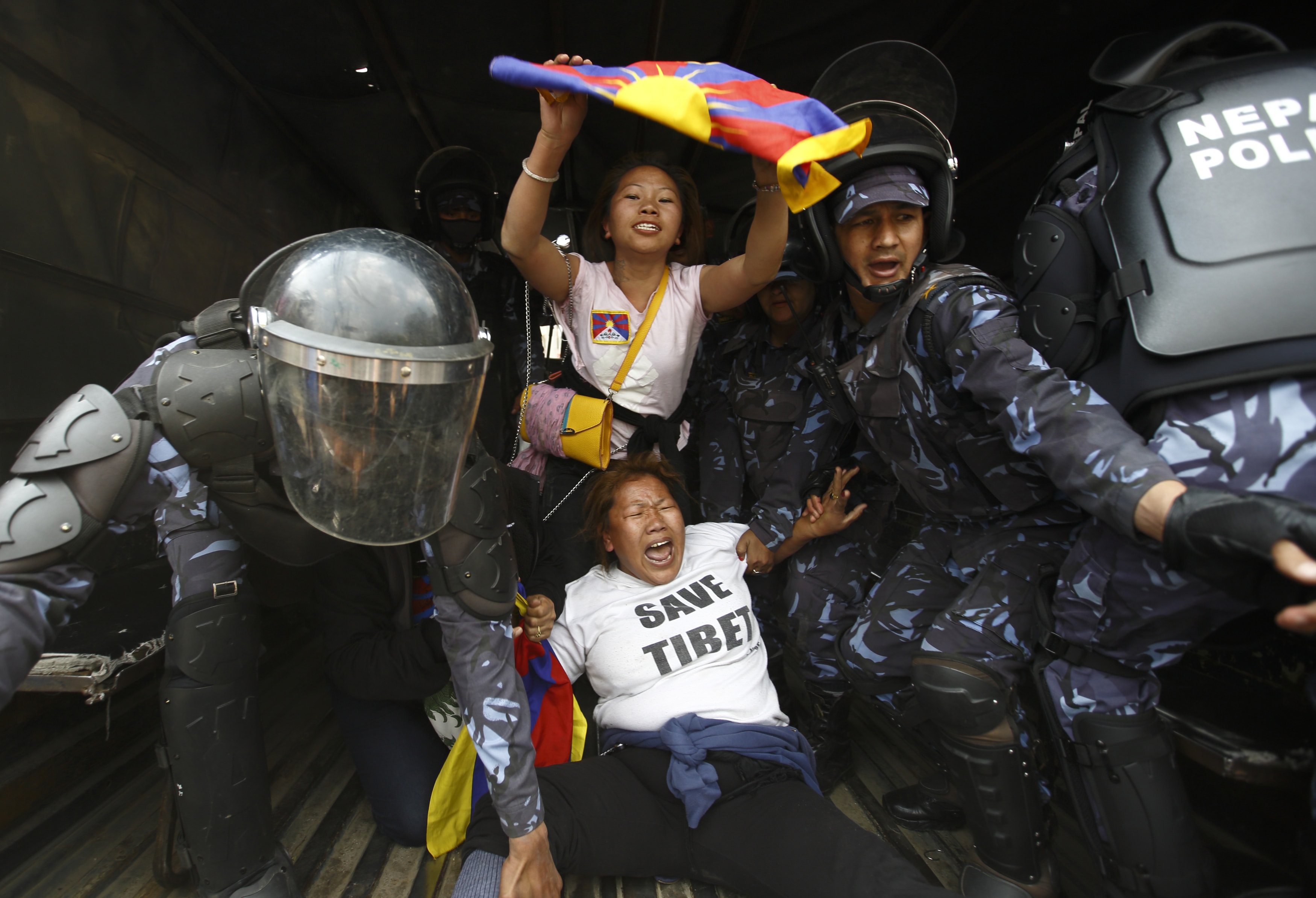 Nepalese police personnel detain Tibetan activists during their protest near the Chinese Embassy Consular office in Kathmandu, 10 March 2014, REUTERS/Navesh Chitrakar