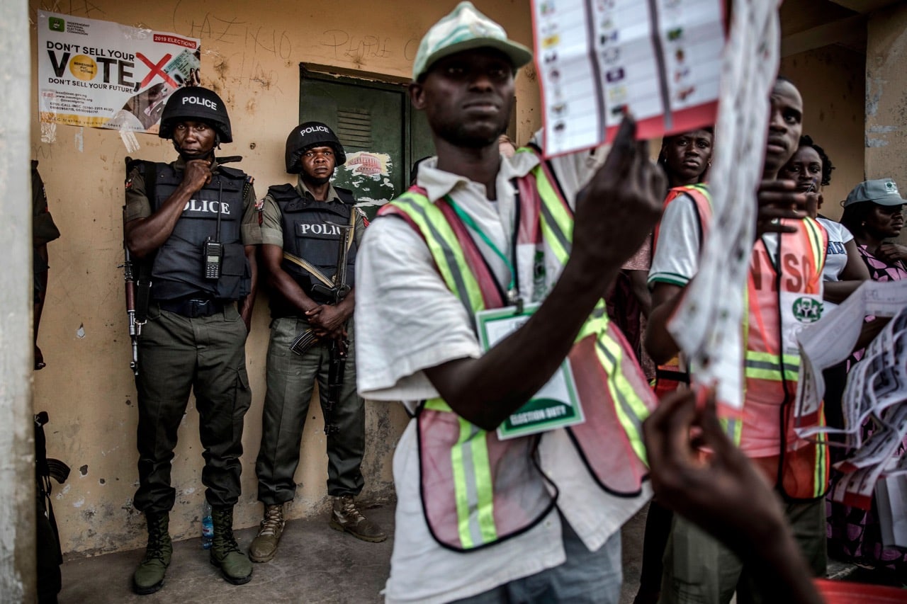 Nigerian Police Officers monitor the counting of votes at Shagari Primary School polling station in Yola, Adamawa State, 23 February 2019, LUIS TATO/AFP/Getty Images