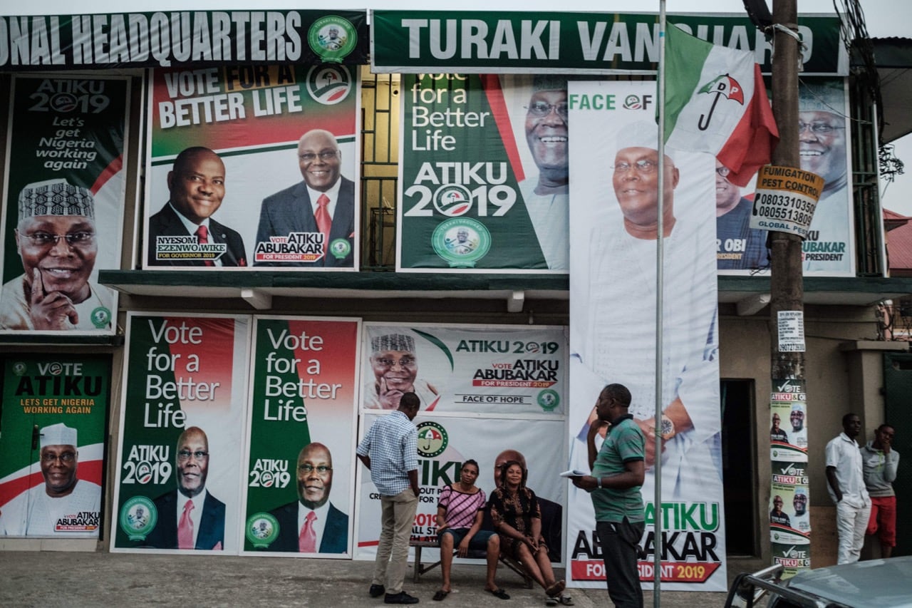 Supporters of the presidential candidate of the main opposition People Democratic Party (PDP), sit in front of the local campaign office in Port Harcourt, southern Nigeria, 15 February 2019, YASUYOSHI CHIBA/AFP/Getty Images