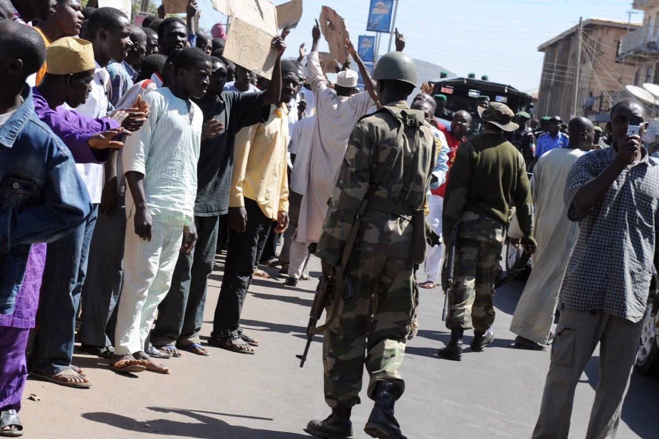 Soldiers patrol the streets during a protest by youth in the central Nigerian city of Jos, Plateau State, 1 December 2008, PIUS UTOMI EKPEI/AFP/Getty Images