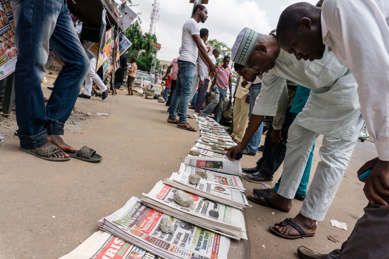 People read newspapers sold in the streets, in Abuja, Nigeria, 8 May 2017, STEFAN HEUNIS/AFP/Getty Images