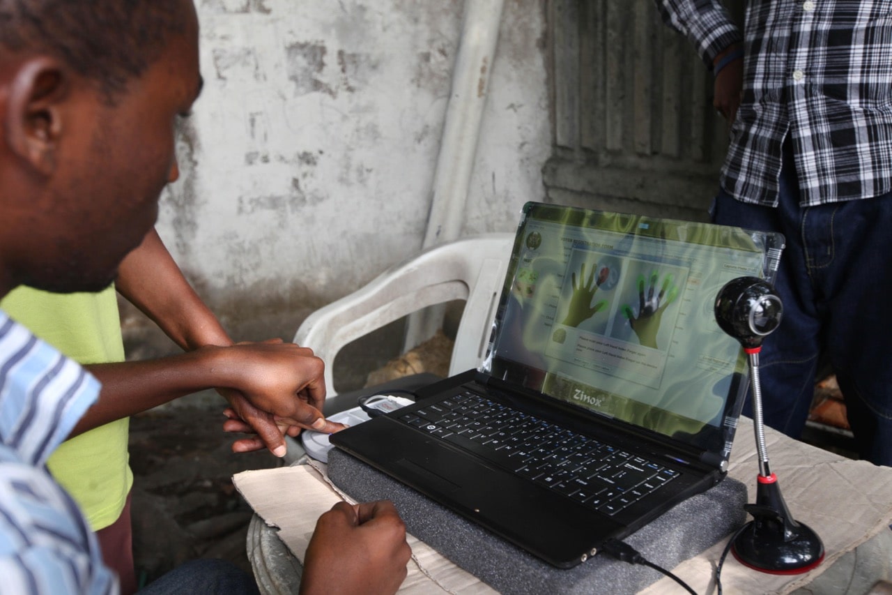 An official takes a fingerprint of a prospective voter using a laptop computer in Lagos, Nigeria, 15 January 2011, AP Photo/Sunday Alamba