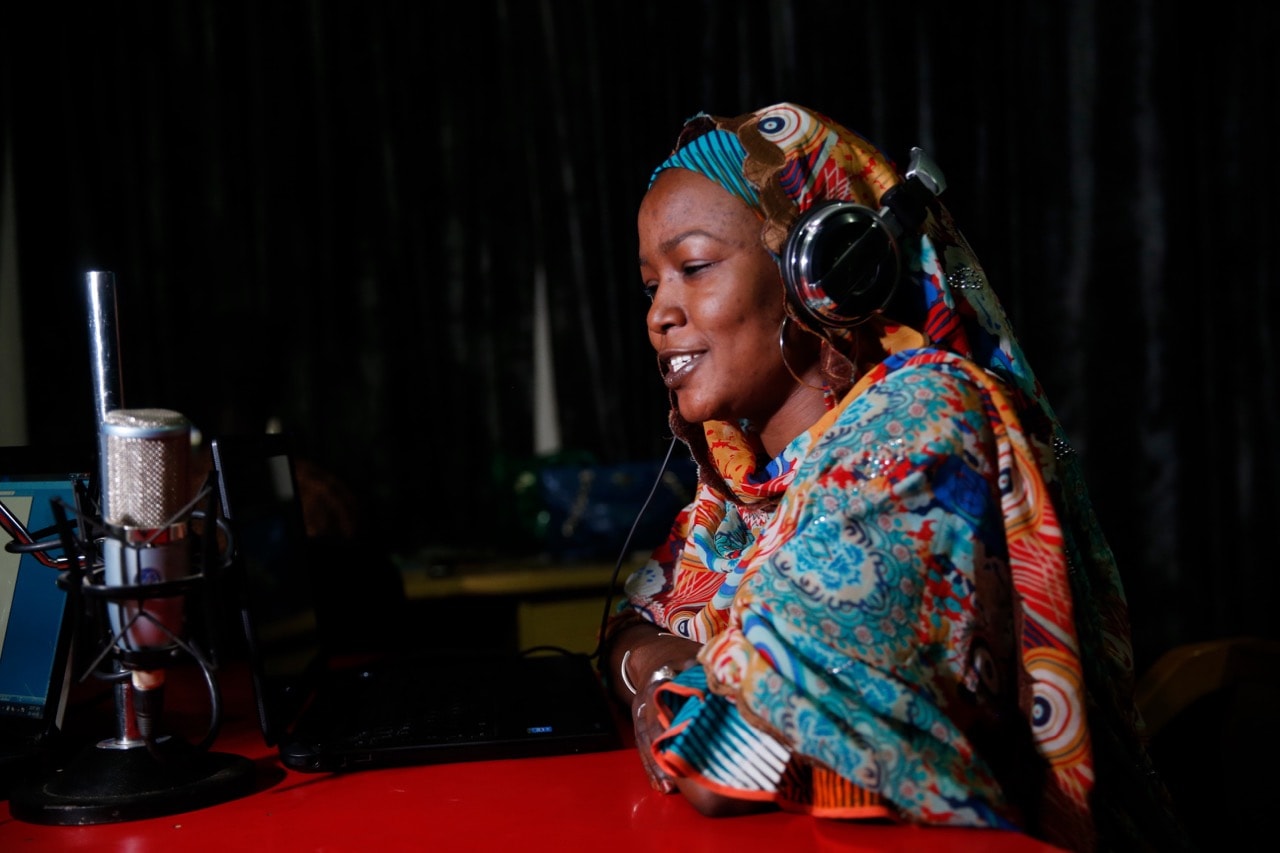 Presenter Halima Abba Ibrahim speaks into a microphone during a shortwave broadcast at a radio station in Nigeria's northern region of Kano, 18 January 2016, REUTERS/Akintunde Akinleye