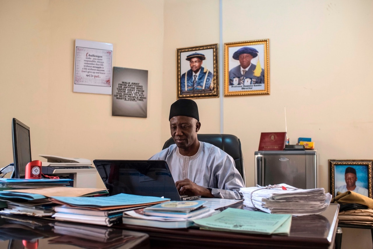 Professor Danjuma Gambo, university spokesperson and director of the University of Maiduguri radio station, works in his office, in Maiduguri, Nigeria, 4 July 2017, STEFAN HEUNIS/AFP/Getty Images