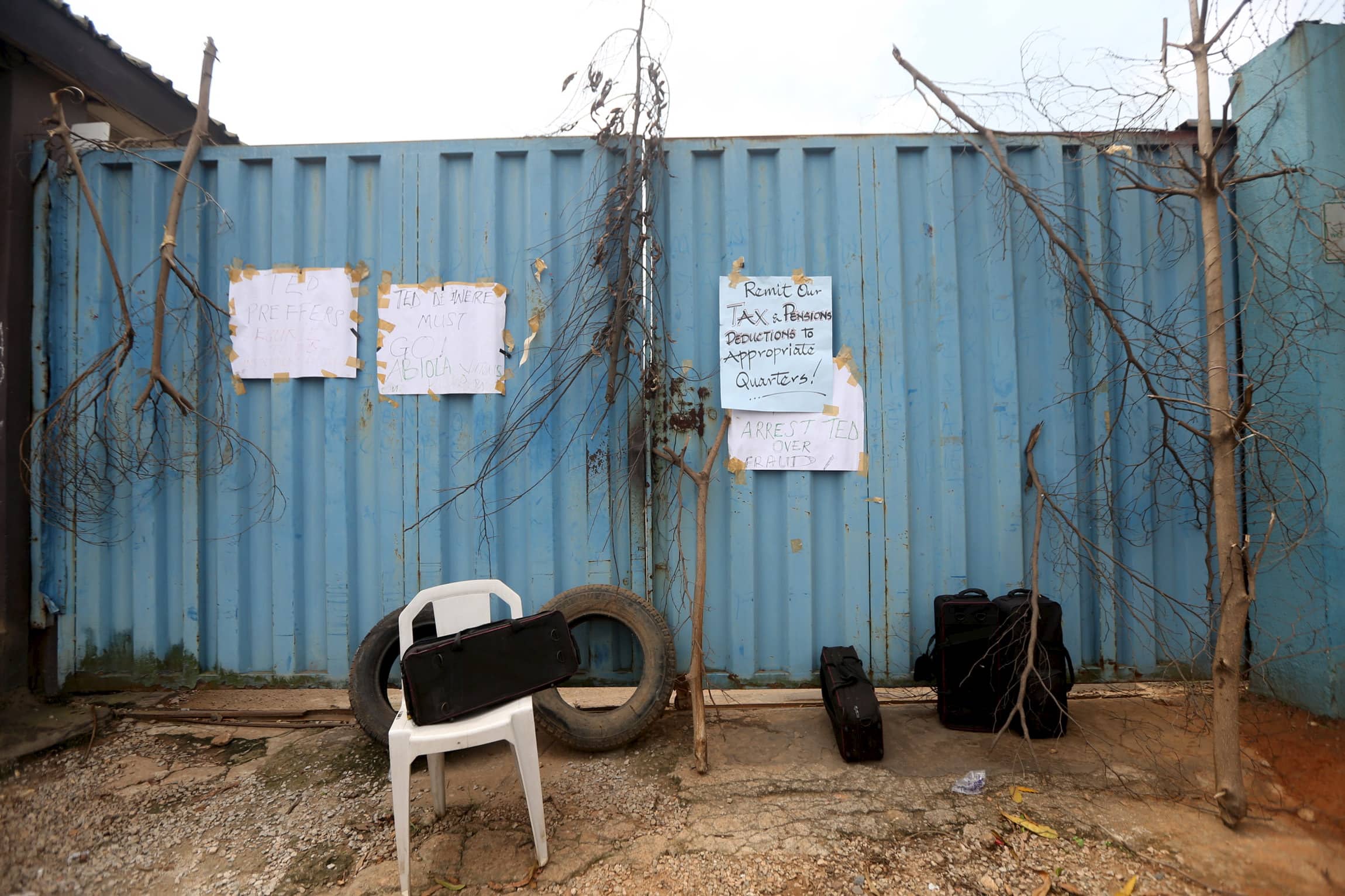 Placards hang from a gate at the entrance of the Daily Independent newspaper, as journalists (not pictured) protest over poor working conditions in Ogba, district of Lagos, 28 October 2015, REUTERS/Akintunde Akinleye