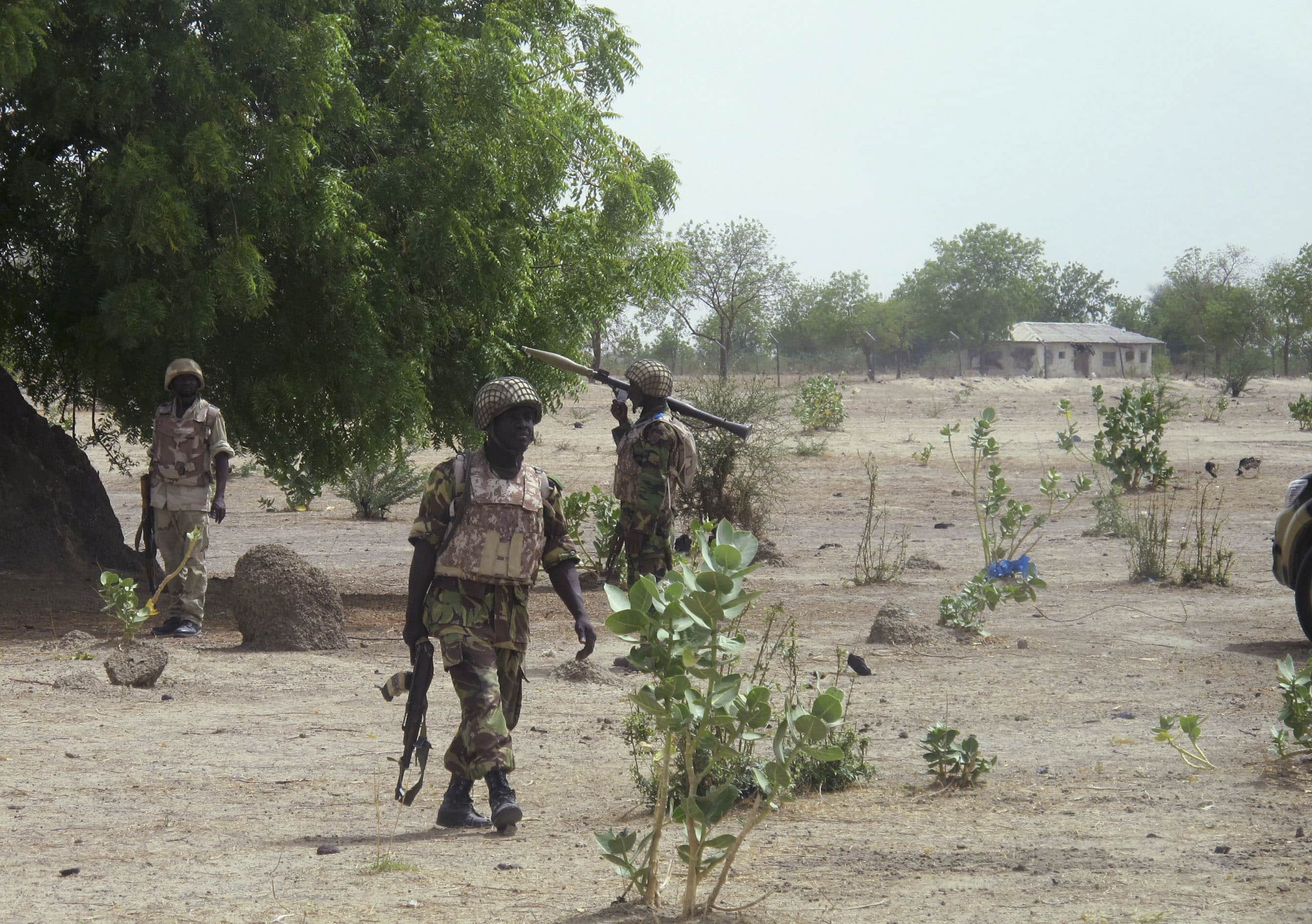 Soldiers walk through Hausari village, Nigeria, during a military patrol, 5 June 2013, REUTERS/Joe Brock