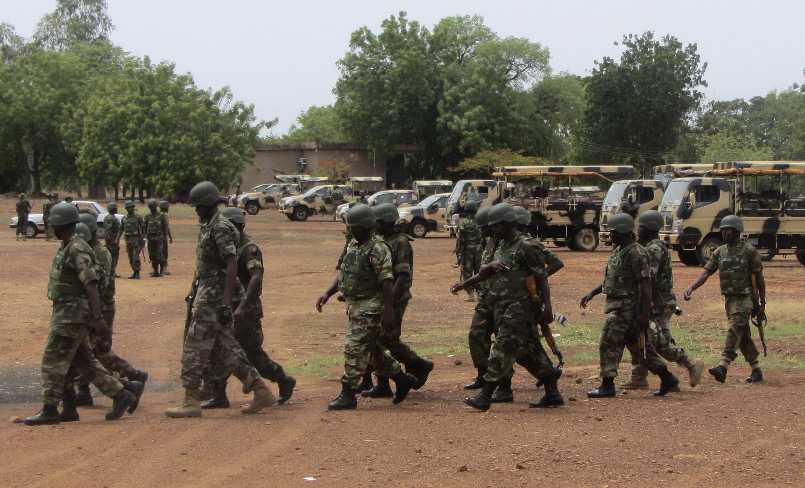 Soldiers from Lagos walk near trucks as they arrive with the 23rd Armoured Brigade in Yola, 20 May 2013, REUTERS/Stringer