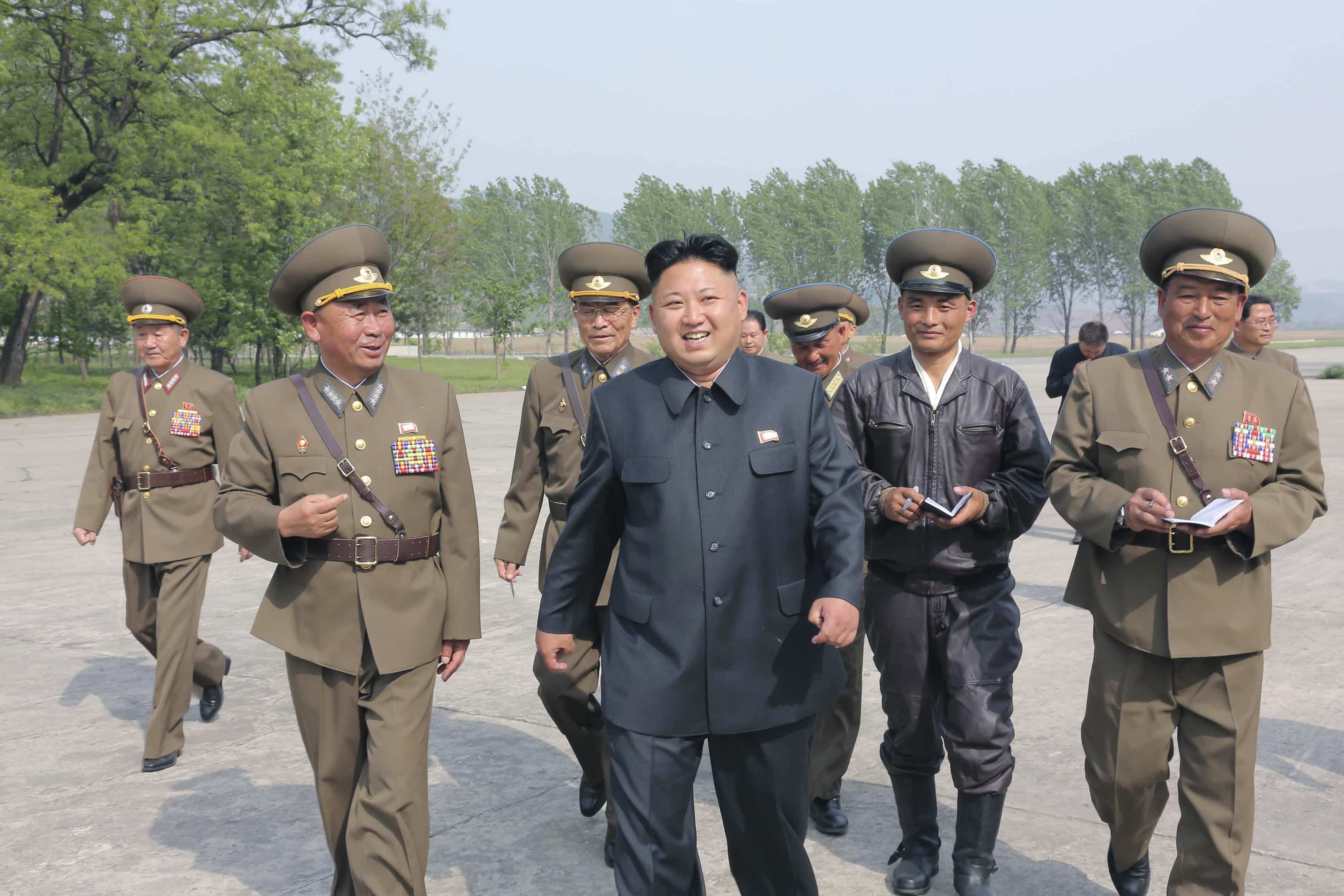 In this undated photo released by the Korean Central News Agency (KCNA), Kim Jong Un (4th L) walks with officials during an inspection of the Korean People's Army Air and Anti-Air Force Unit 447, REUTERS/KCNA