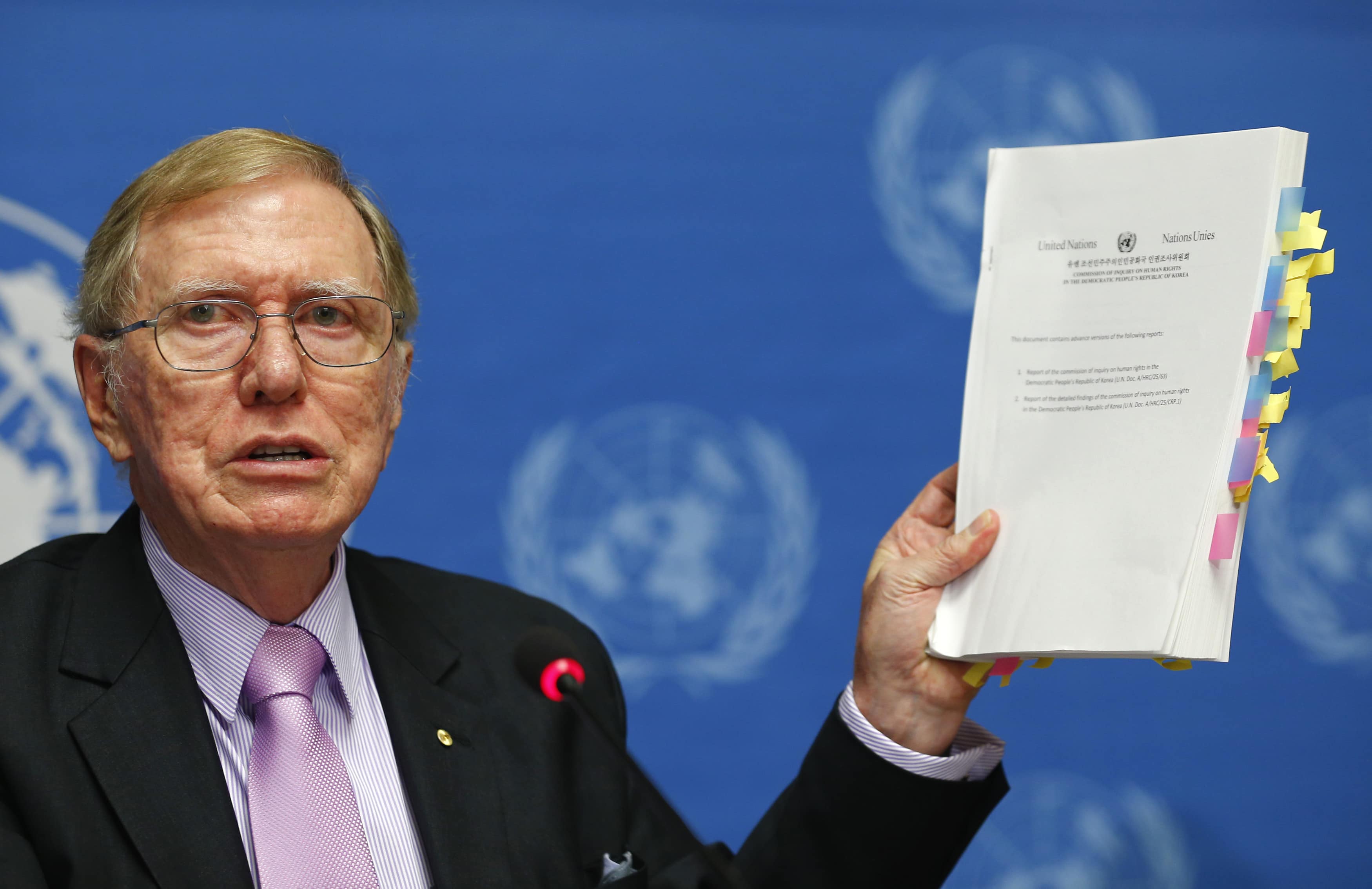 Michael Kirby, Chairperson of the Commission of Inquiry on Human Rights in North Korea, holds a copy of his report during a news conference at the United Nations in Geneva, 17 February 2014, REUTERS/Denis Balibouse