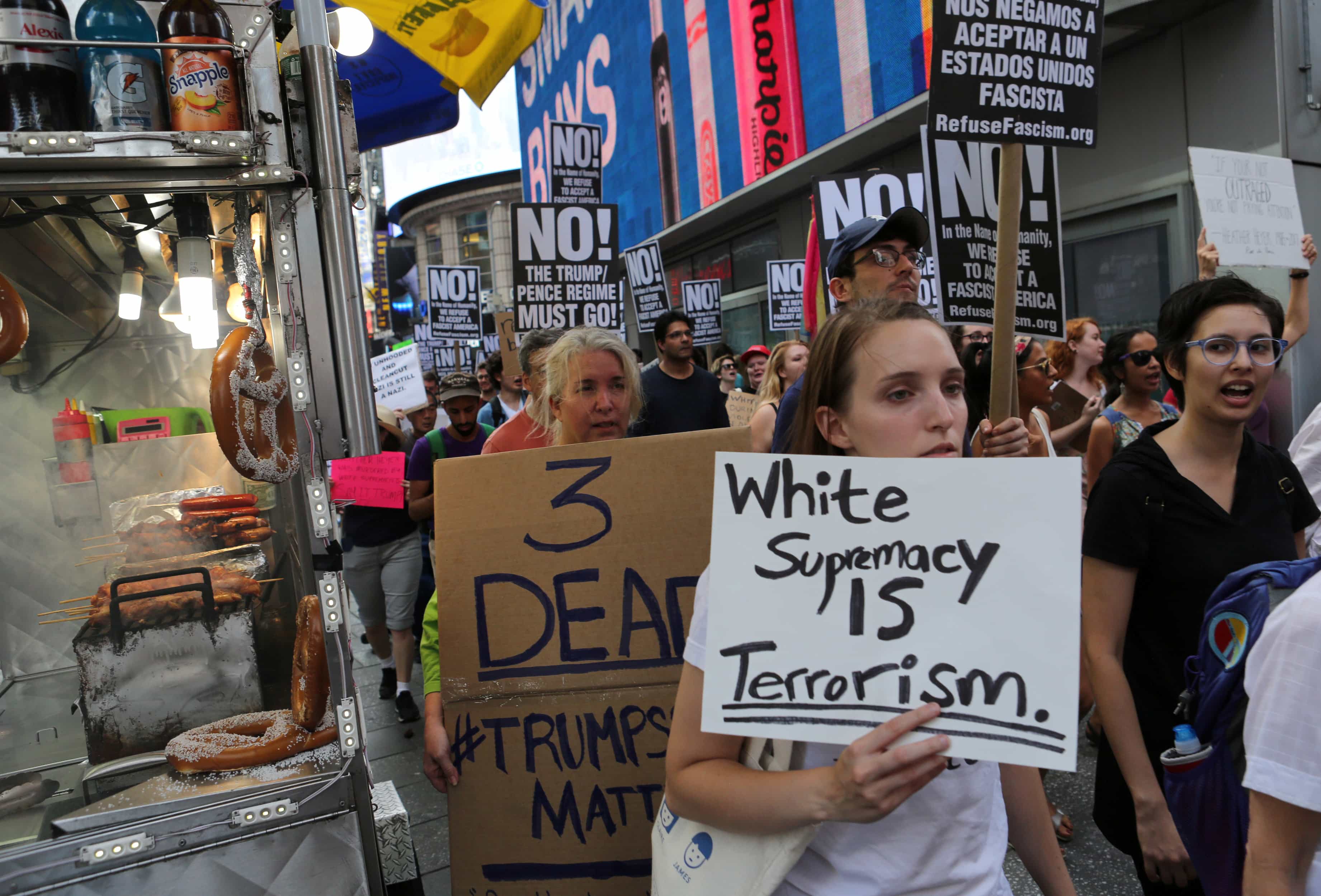 A protester holds a sign reading "White supremacy is terrorism" at a march against white nationalism in New York City, 13 August 2017, REUTERS/Joe Penney