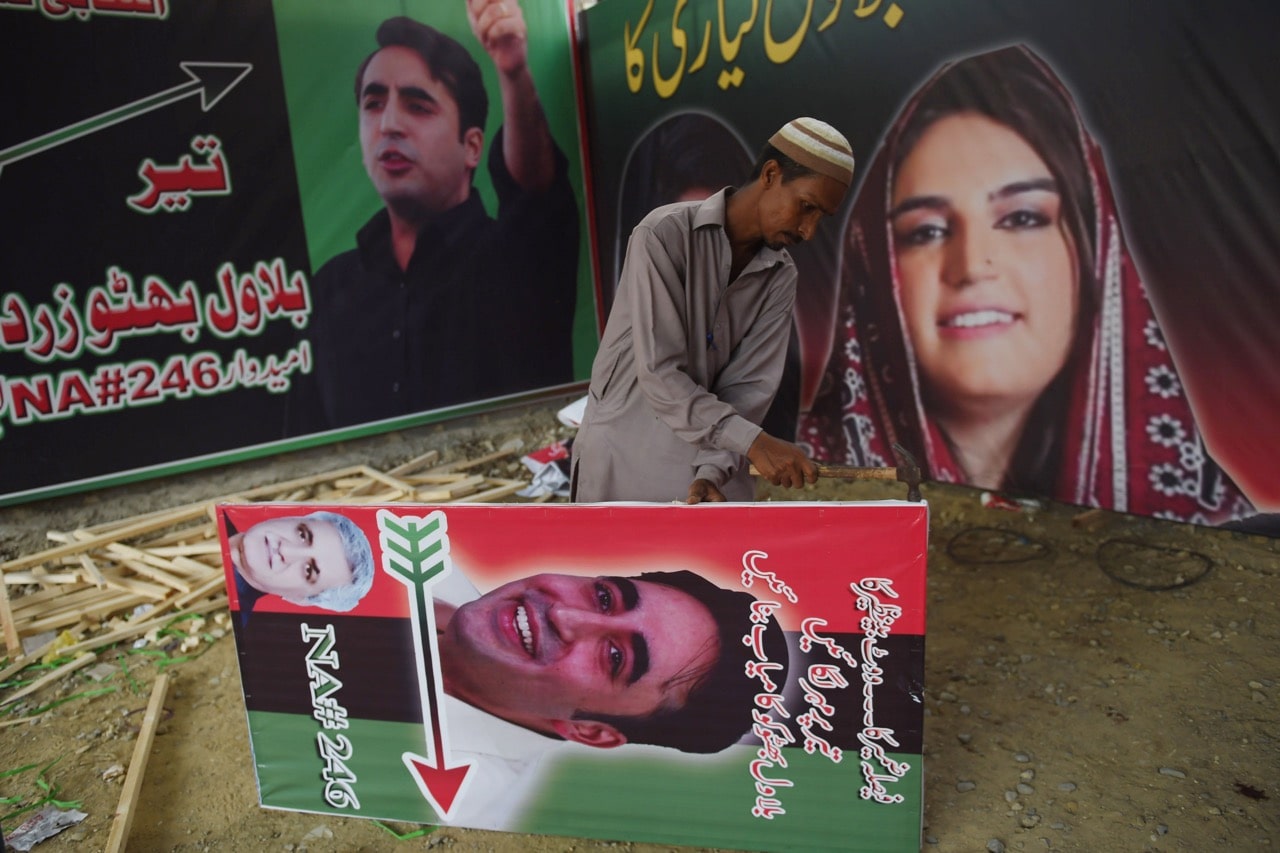 A supporter of Bilawal Bhutto Zardari, chairman of the Pakistan Peoples Party (PPP), prepares an election poster in Karachi, 2 July 2018, RIZWAN TABASSUM/AFP/Getty Images