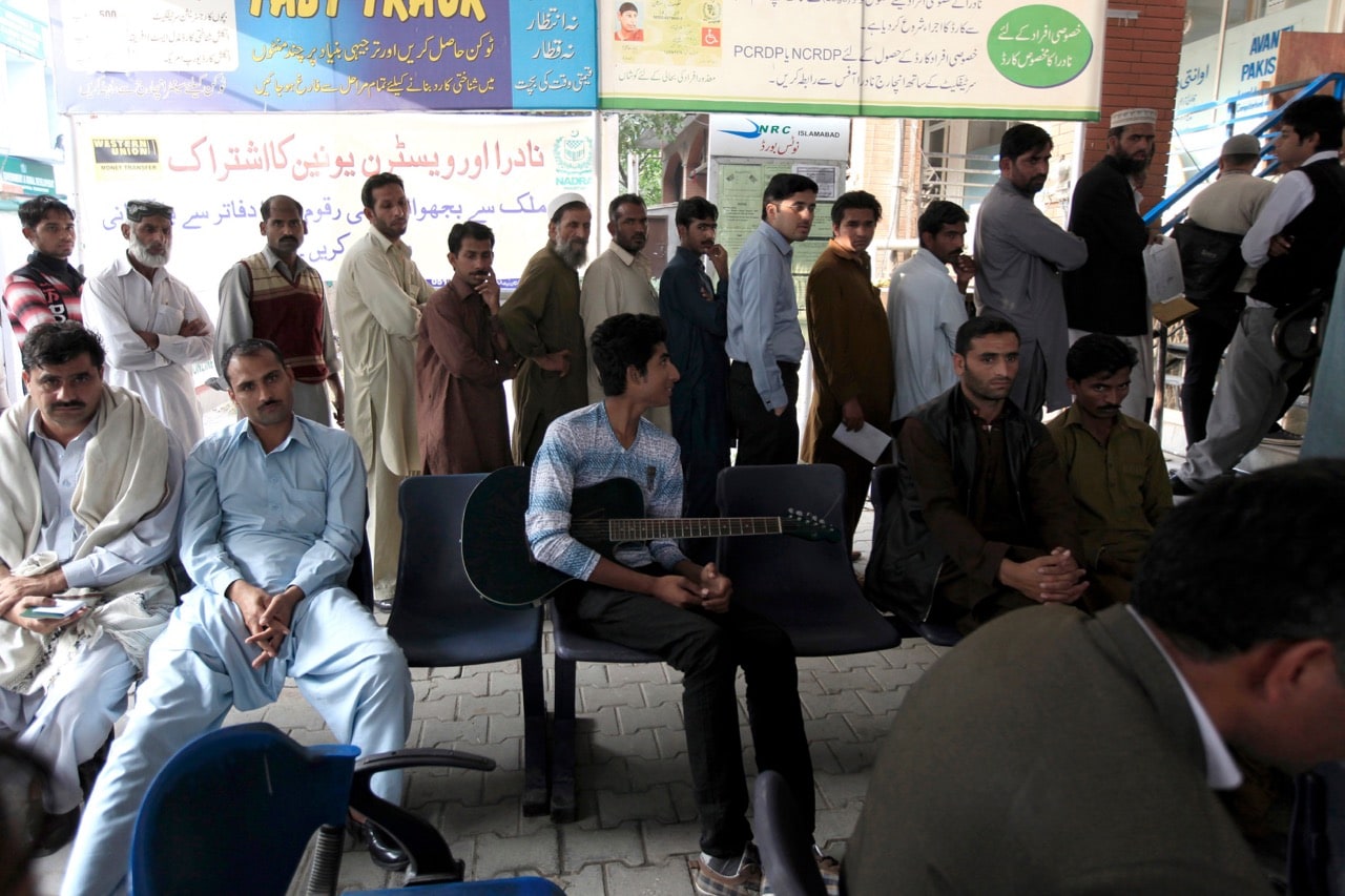 People wait in line to be photographed, fingerprinted and questioned to register for the government identity card outside the NADRA office in Islamabad, Pakistan, 14 November 2012, REUTERS/Faisal Mahmood