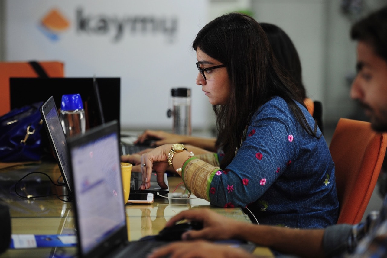 Employees of an online marketplace company are seen at work in Karachi, Pakistan, 19 November 2015, ASIF HASSAN/AFP/Getty Images