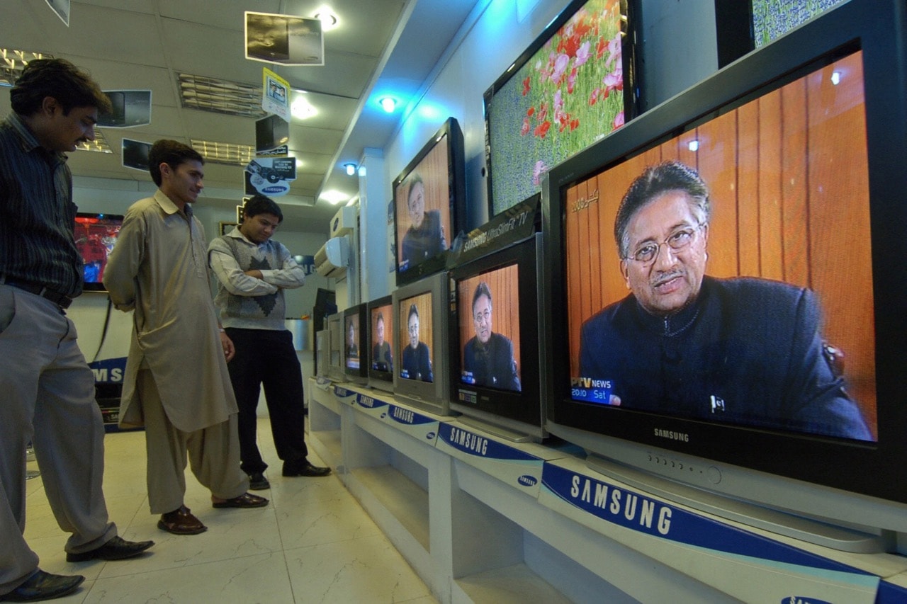 People listen to a speech by then Pakistani President Pervez Musharraf being broadcast on state-run Pakistan Television, in Karachi, 15 December 2007, ASIF HASSAN/AFP/Getty Images