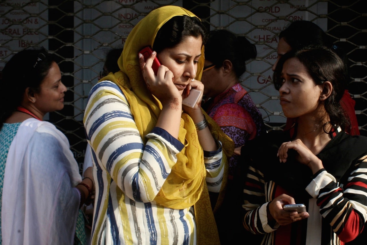 A woman speaks on her mobile phone following a major earthquake that struck Baluchistan province, Pakistan, 24 September 2013, AP Photo/Shakil Adil