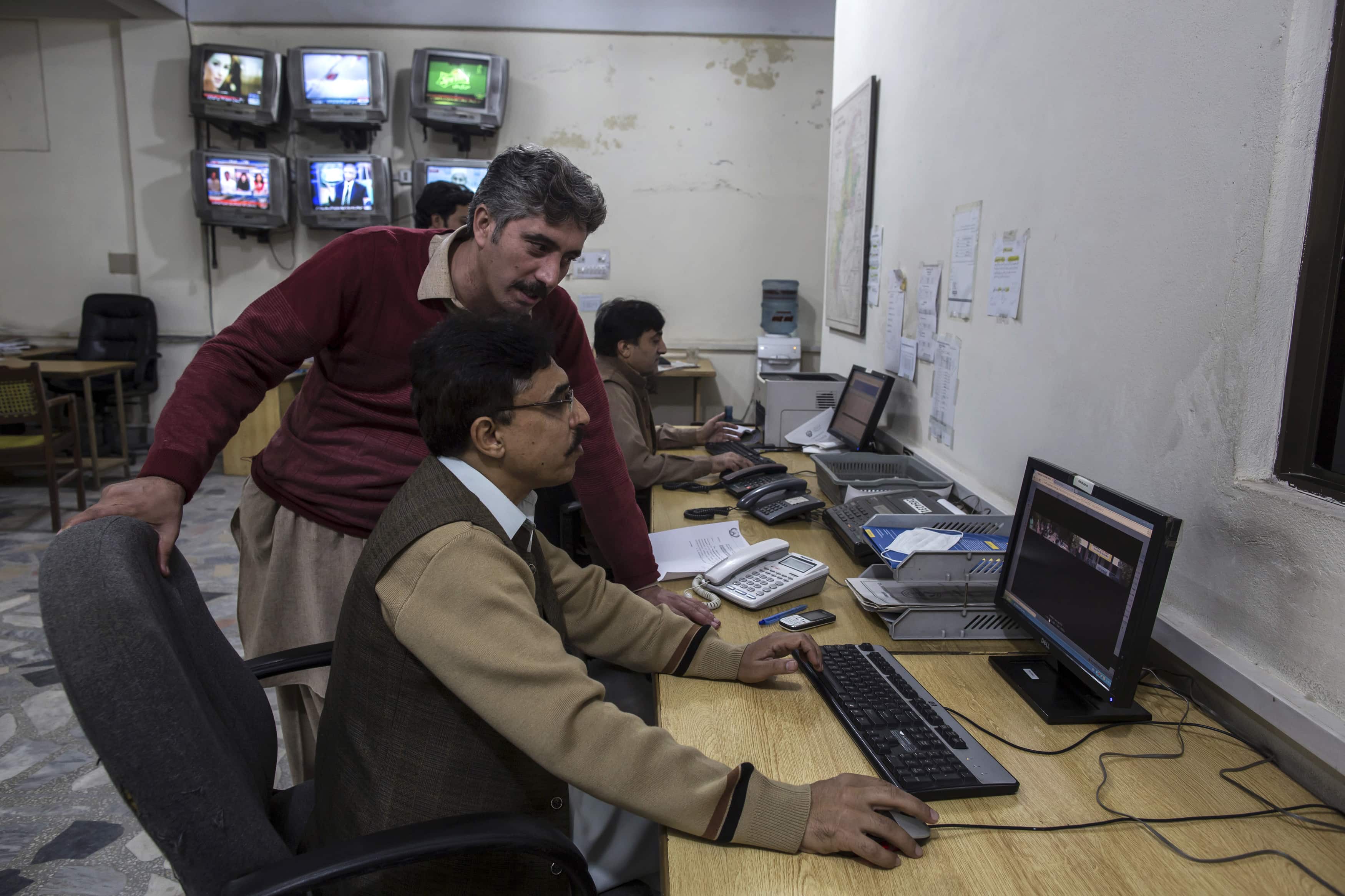 Jamshed Baghwan, the bureau chief for Express News, works in the newsroom in Peshawar, 24 November 2014, REUTERS/Zohra Bensemra