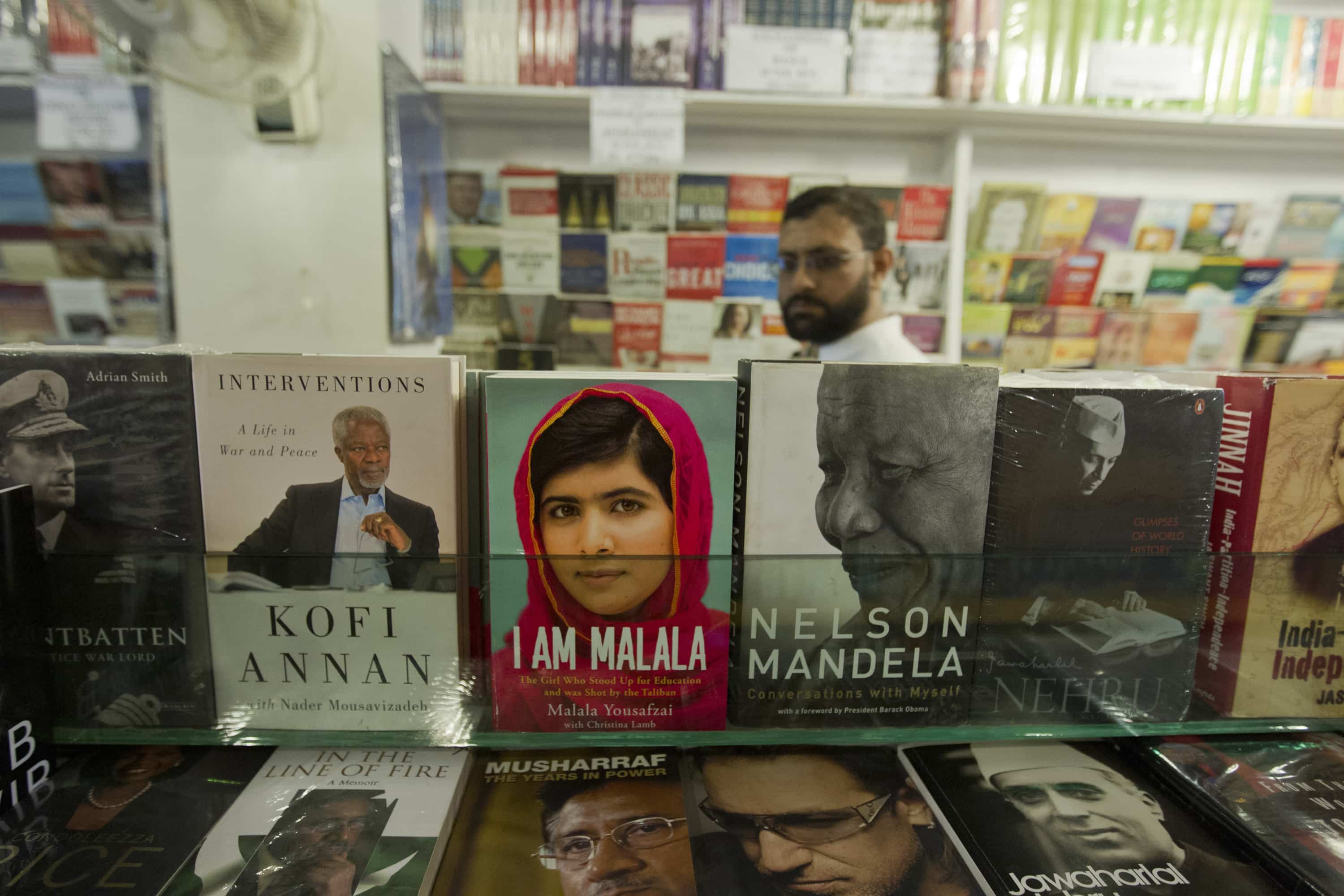 A man walks in a book store as a copy of Malala Yousufzai's book "I am Malala" sits on display, in Islamabad, 8 October 2013 , REUTERS/Mian Khurshee