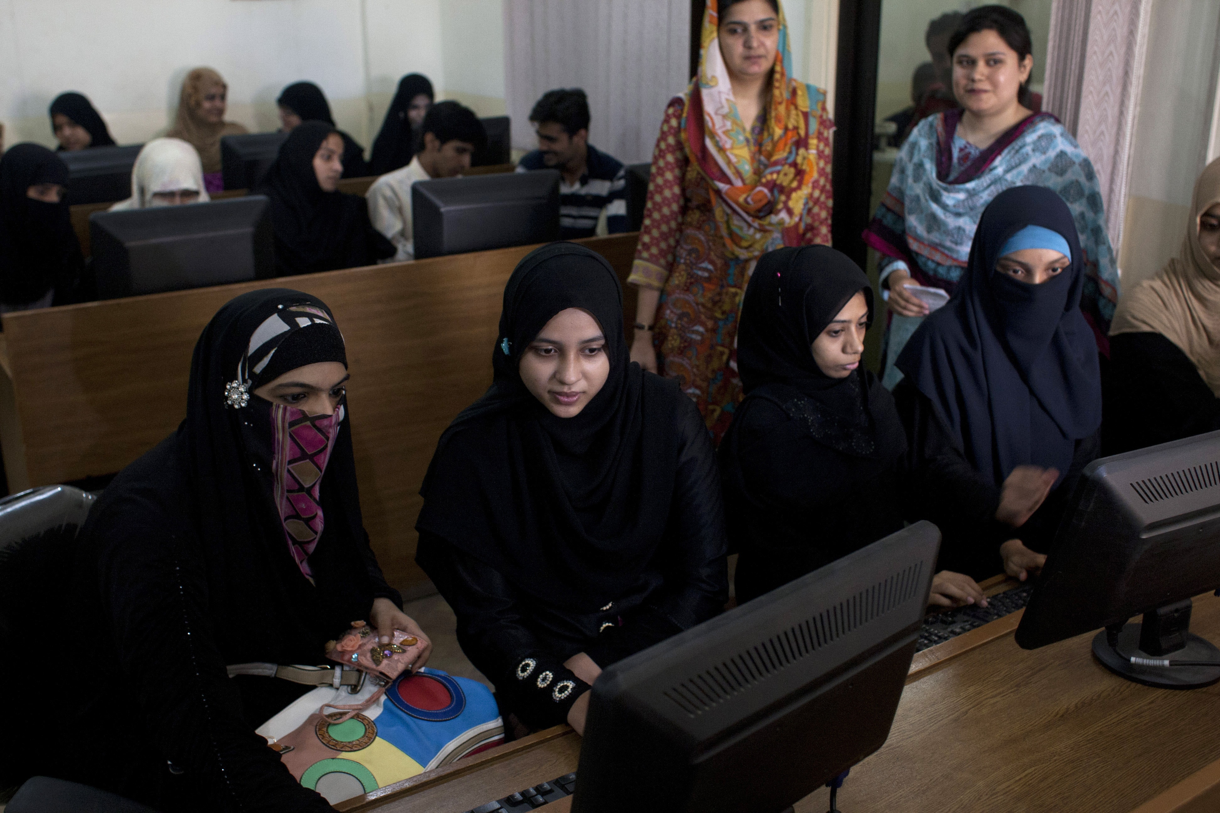 In this 5 September 2013 photo, Pakistani university students surf the Internet in Karachi, Pakistan, AP Photo/Shakil Adil