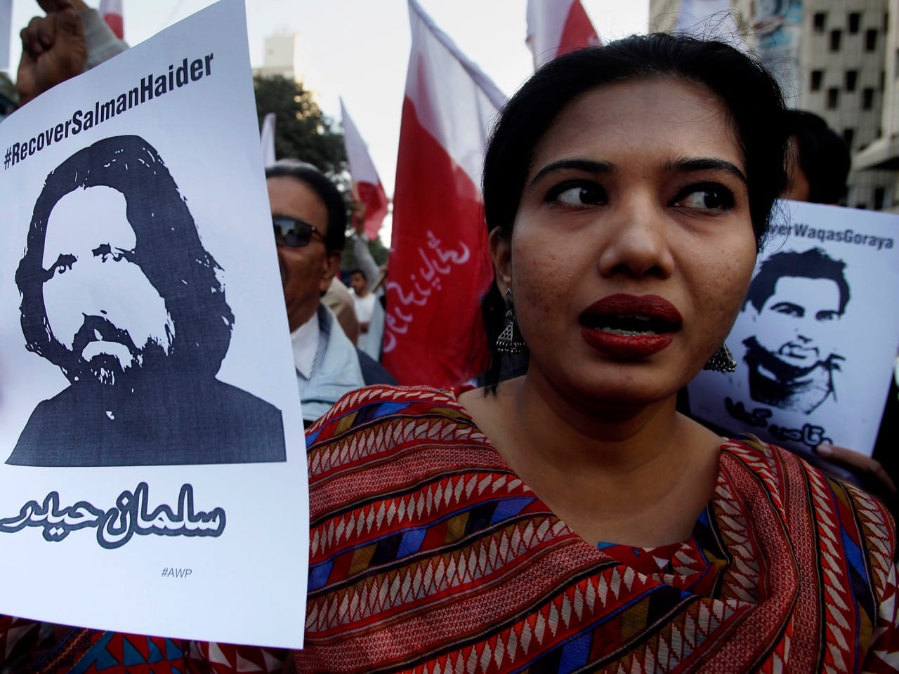 A woman holds a portrait of missing academic Salman Haider during a demonstration to condemn the disappearance of the human rights activists, in Karachi, Pakistan, 10 January 2017, AP Photo/Fareed Khan