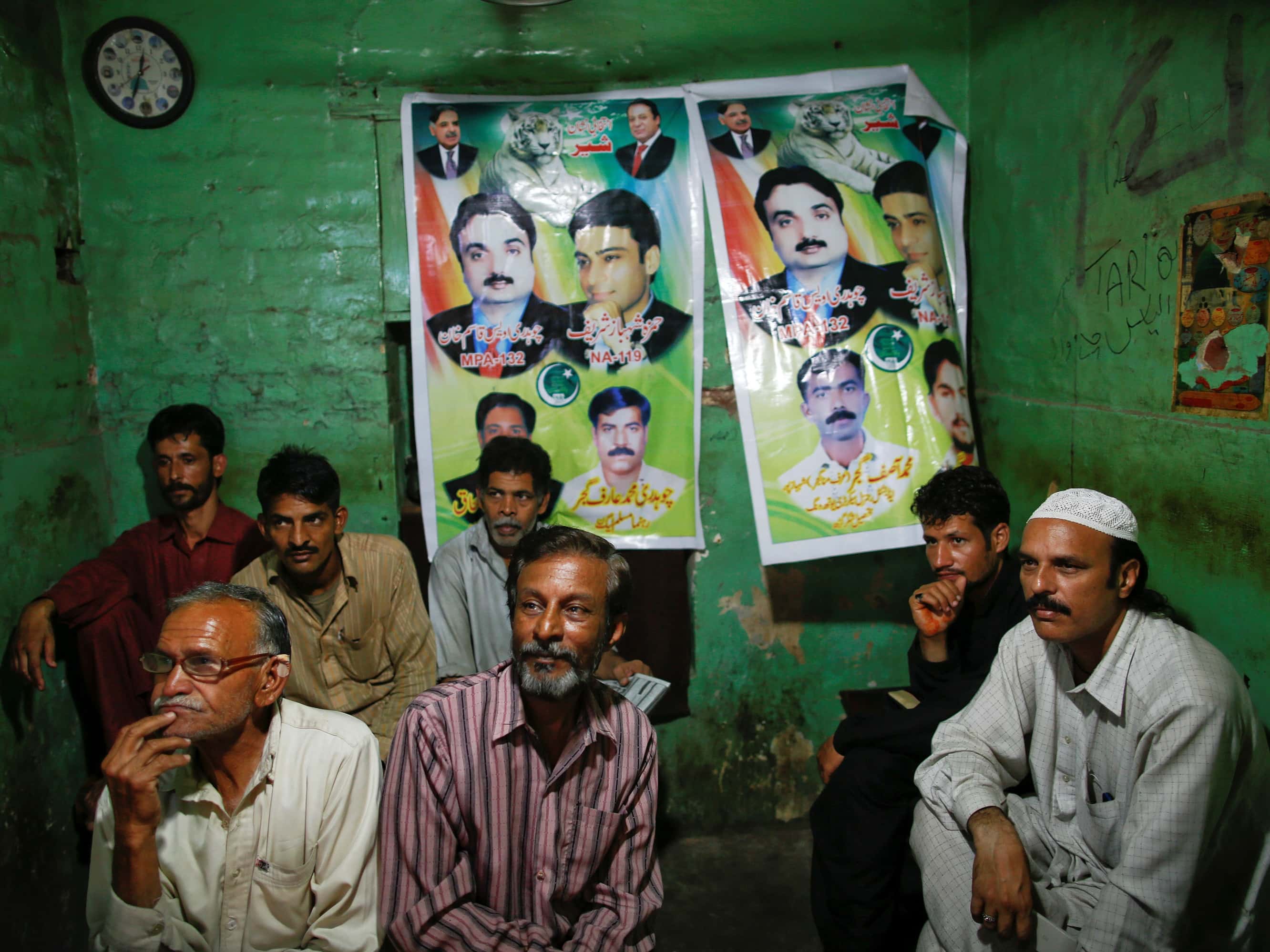 People watch news on TV in a traditional tea shop in Lahore, 10 May 2013, REUTERS/Damir Sagolj