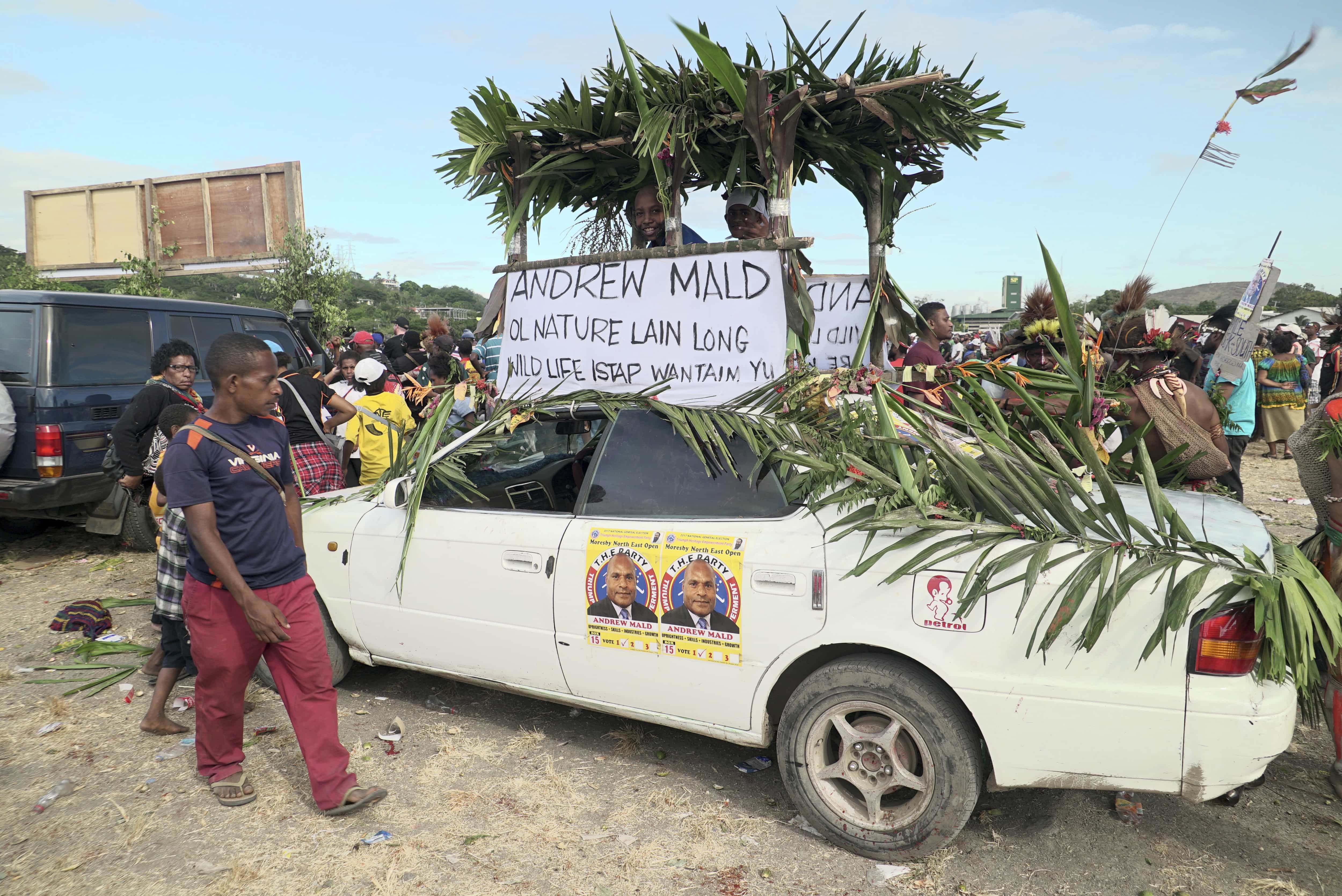 In this 21 June 2017 photo, a car is decorated with voting posters at an election rally in the Papua New Guinea capital, Port Moresby, Eric Tlozek/ABC via AP