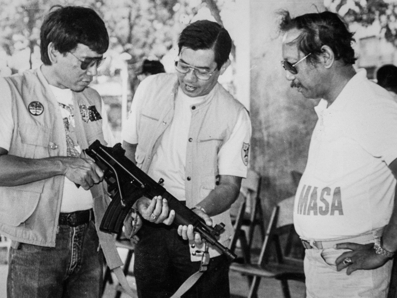 Then Mayor Rodrigo Duterte (L) inspects an assault rifle at a shooting range in Davao city with Regional Police Chief Miguel Abaya (C) and Metrodiscom chief Franco Calida. Picture taken in the late 1980s, REUTERS/Renato Lumawag