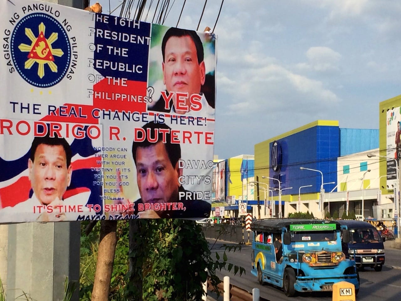 A jeepney drives past an election poster of Philippine presidential candidate Rodrigo Duterte in Davao city, 22 April 2016, REUTERS/Martin Petty