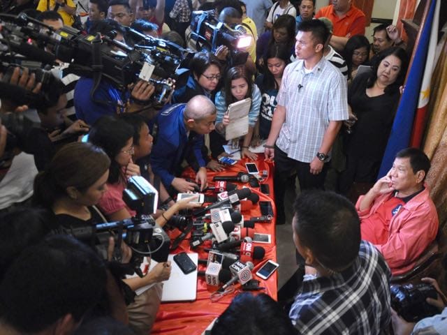 President-elect Rodrigo Duterte, seated right, answers questions from the media during a news conference, 26 May 2016 in Davao city, King Rodriguez, Office of the City Mayor Davao via AP