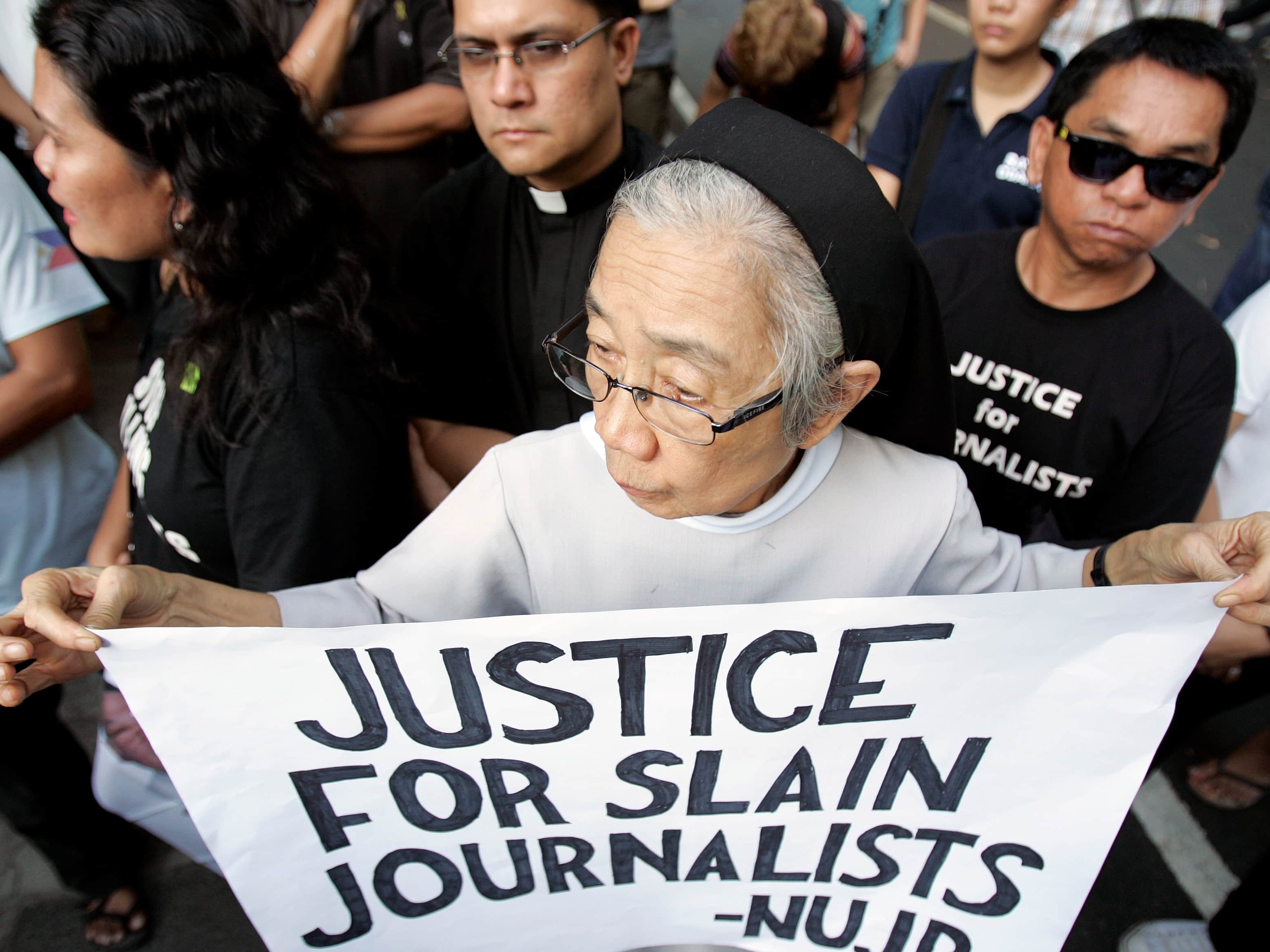 In April 2010, a Roman Catholic nun takes part in a protest in Manila by relatives of journalists killed in the Ampatuan massacre, REUTERS/Romeo Ranoco