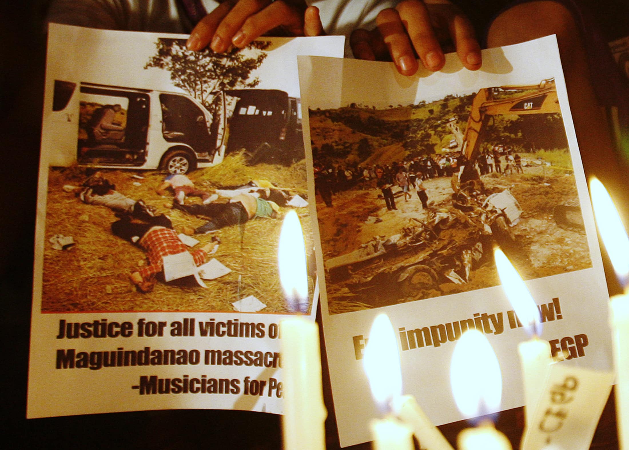 Student activists hold photos calling for justice for the Ampatuan Massacre during a candle lighting ceremony, ahead of the one year anniversary in Quezon City Metro Manila, 21 November 2010, REUTERS/Cheryl Ravelo