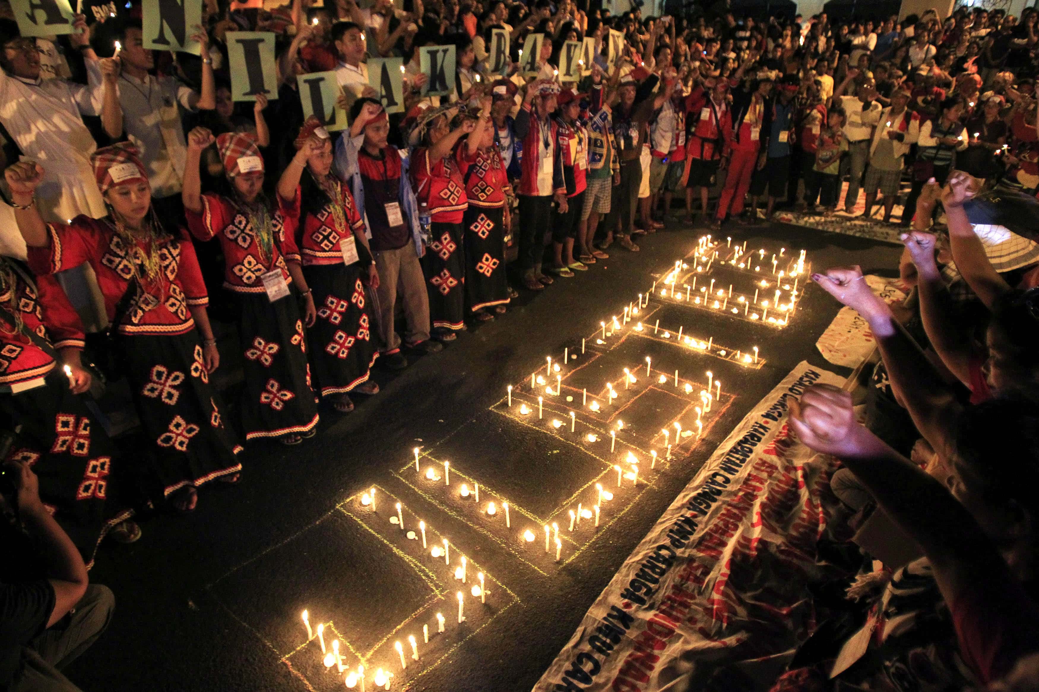 Candles spell out "Justice" for the victims of the 2009 murder of 32 journalists during a protest in Paranaque city, metro Manila, 23 November 2014, REUTERS/Romeo Ranoco
