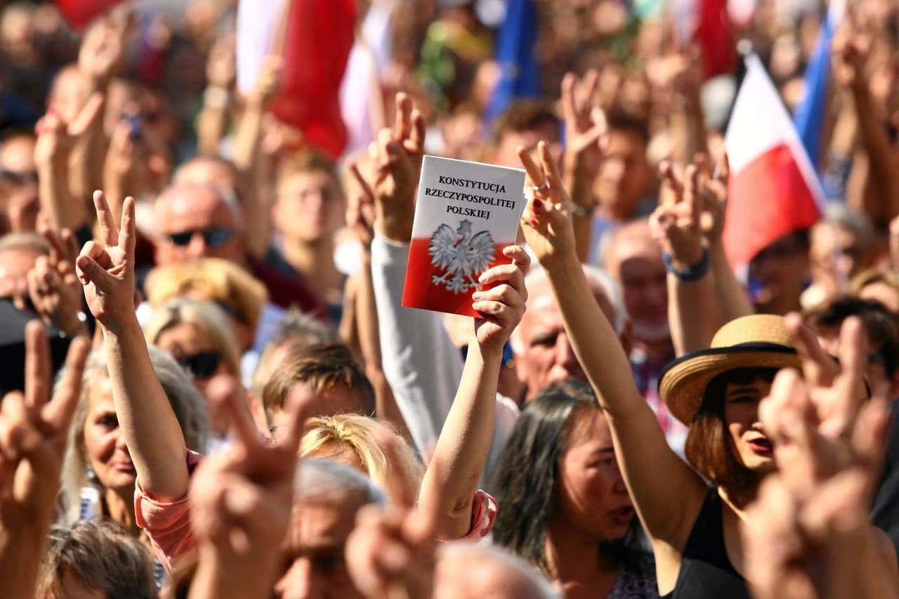 A protester holds a copy of the Polish Constitution during an opposition protest at the Market Square in Krakow, Poland, 16 July 2017, Agencja Gazeta/Jakub Porzycki via REUTERS