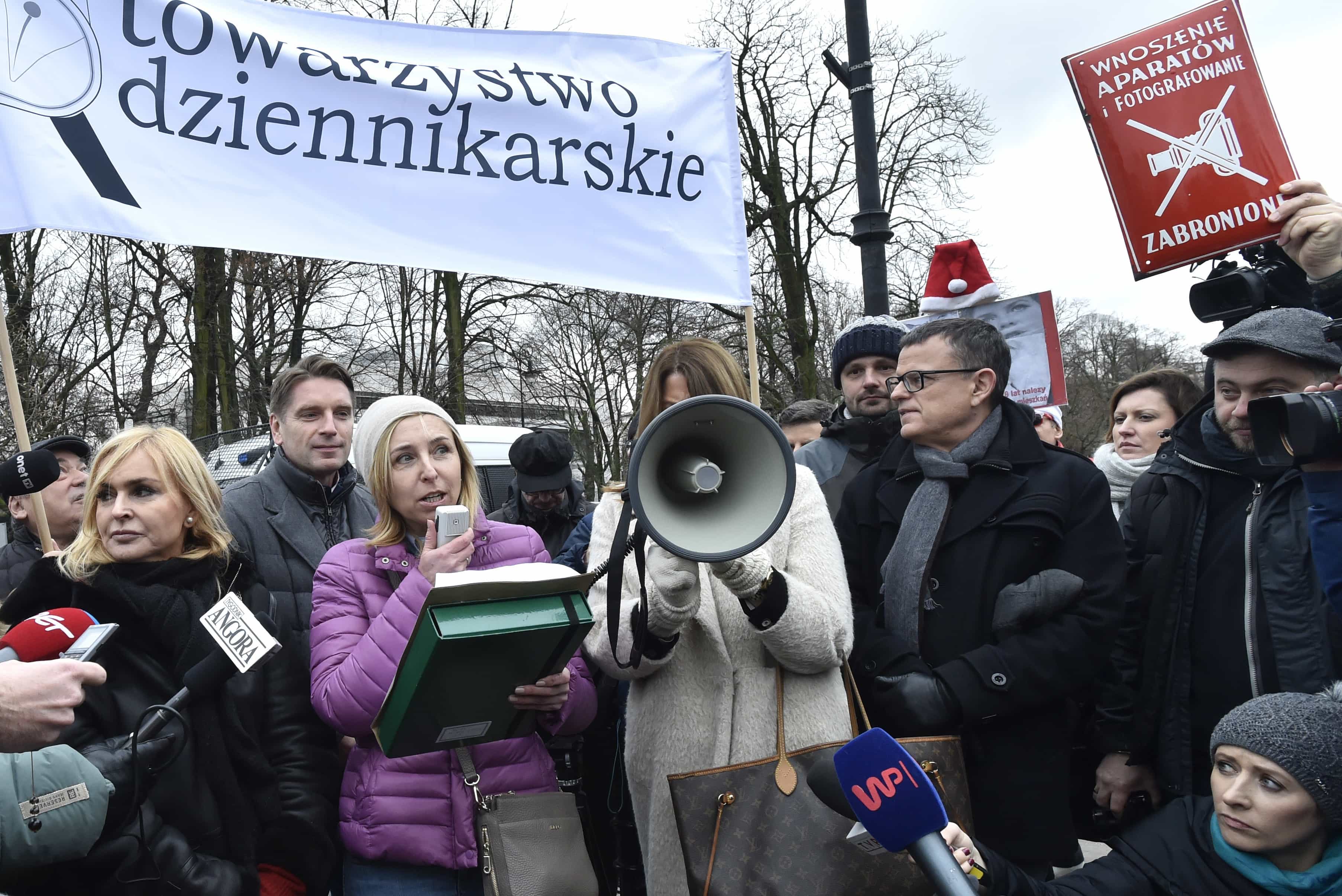 In this 15 December 2016 photo, journalists protest in front of the parliament in Warsaw, Poland, as the ruling Law and Justice party planned to set new rules to drastically limit reporters' access in parliament, AP Photo/Alik Keplicz