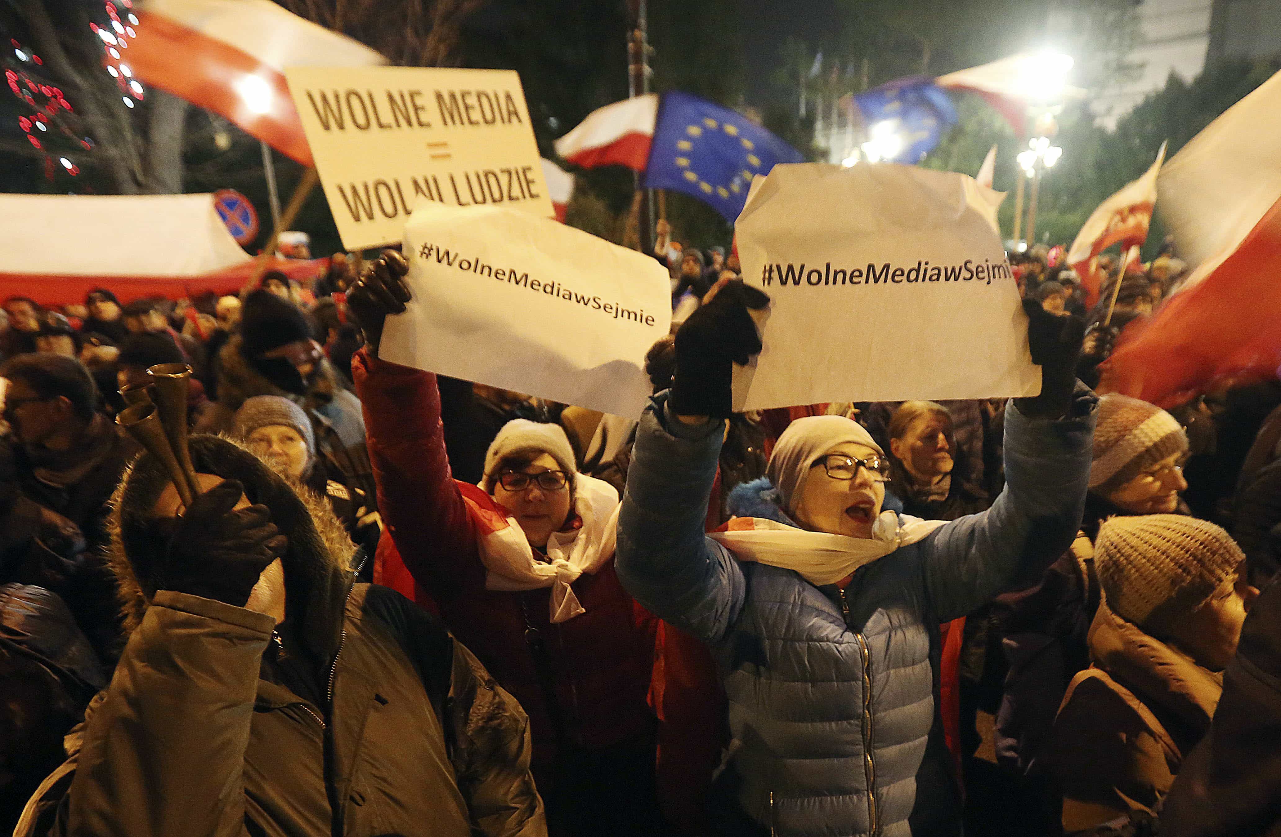 People gather to demonstrate outside the Parliament building in Warsaw, Poland on 16 December 2016, in support of opposition lawmakers protesting against the ruling party's plans to limit media access to lawmakers, AP Photo/Czarek Sokolowski