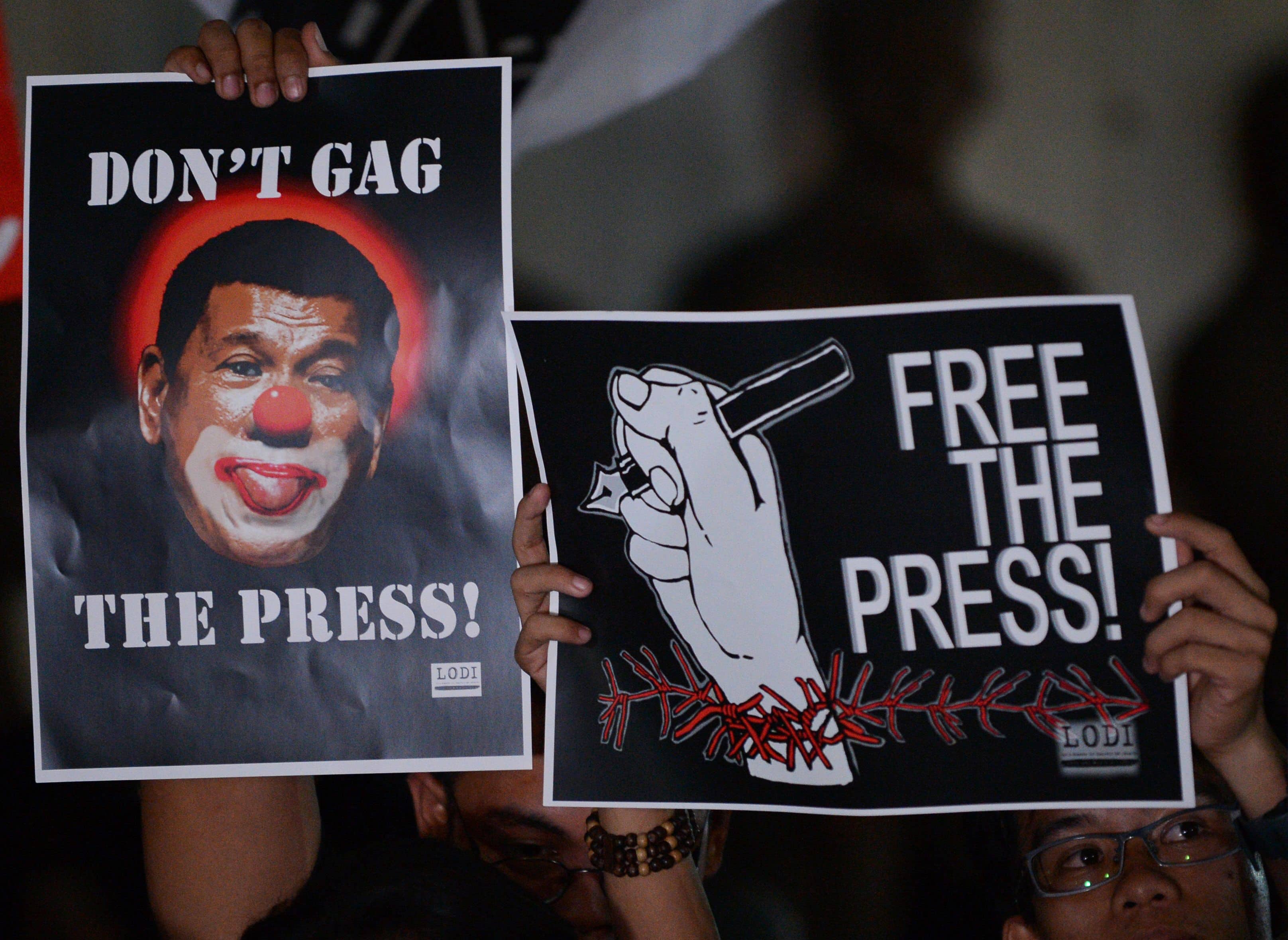 Journalists and supporters display placards showing President Rodrigo Duterte as a clown during a protest in support of Rappler Manila on January 19, 2018, TED ALJIBE/AFP/Getty Images