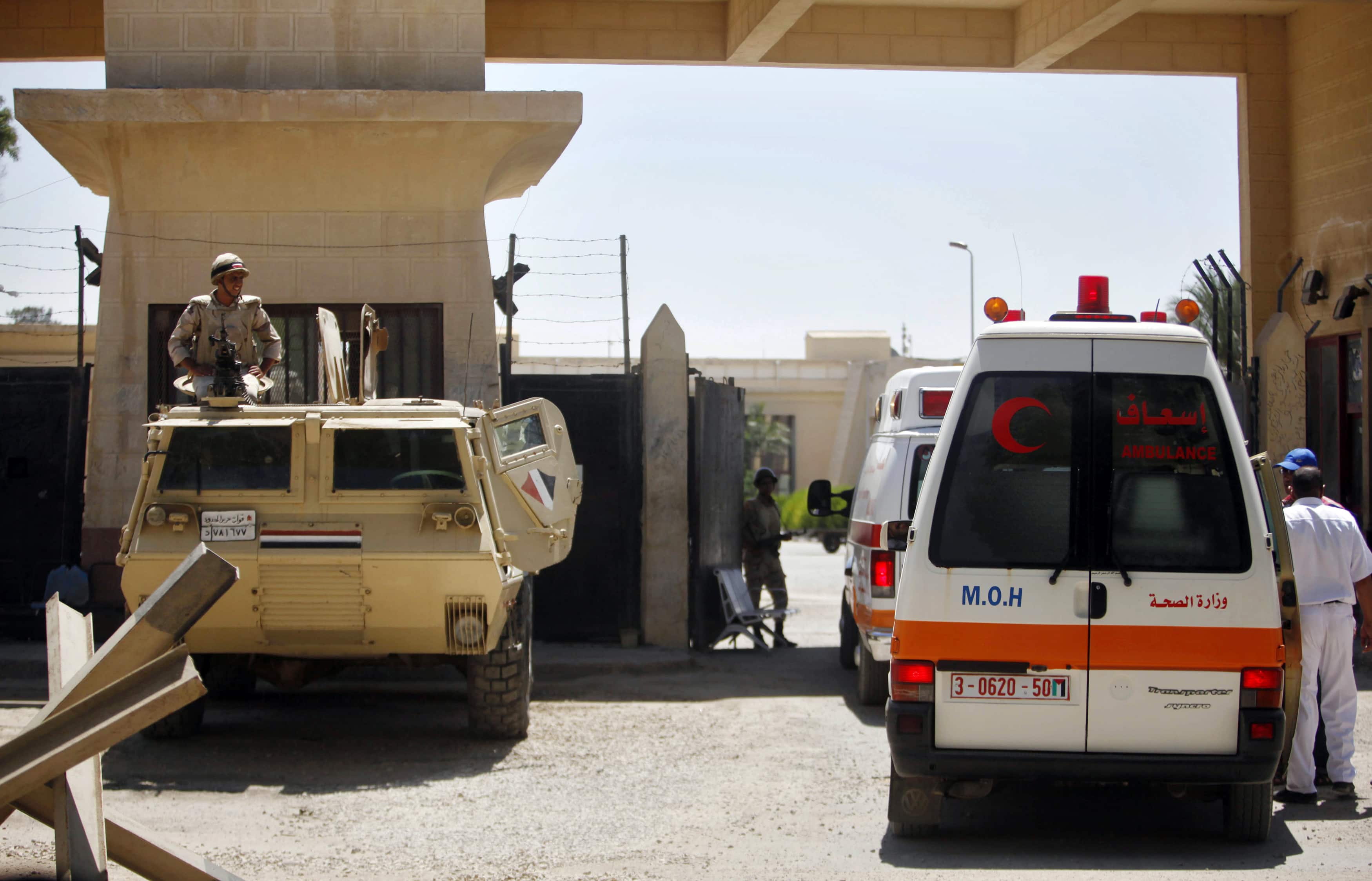 Ambulances transporting wounded people cross to the Egyptian side of Rafah crossing in southern Gaza Strip on 10 July 2014, REUTERS/Ibraheem Abu Mustafa