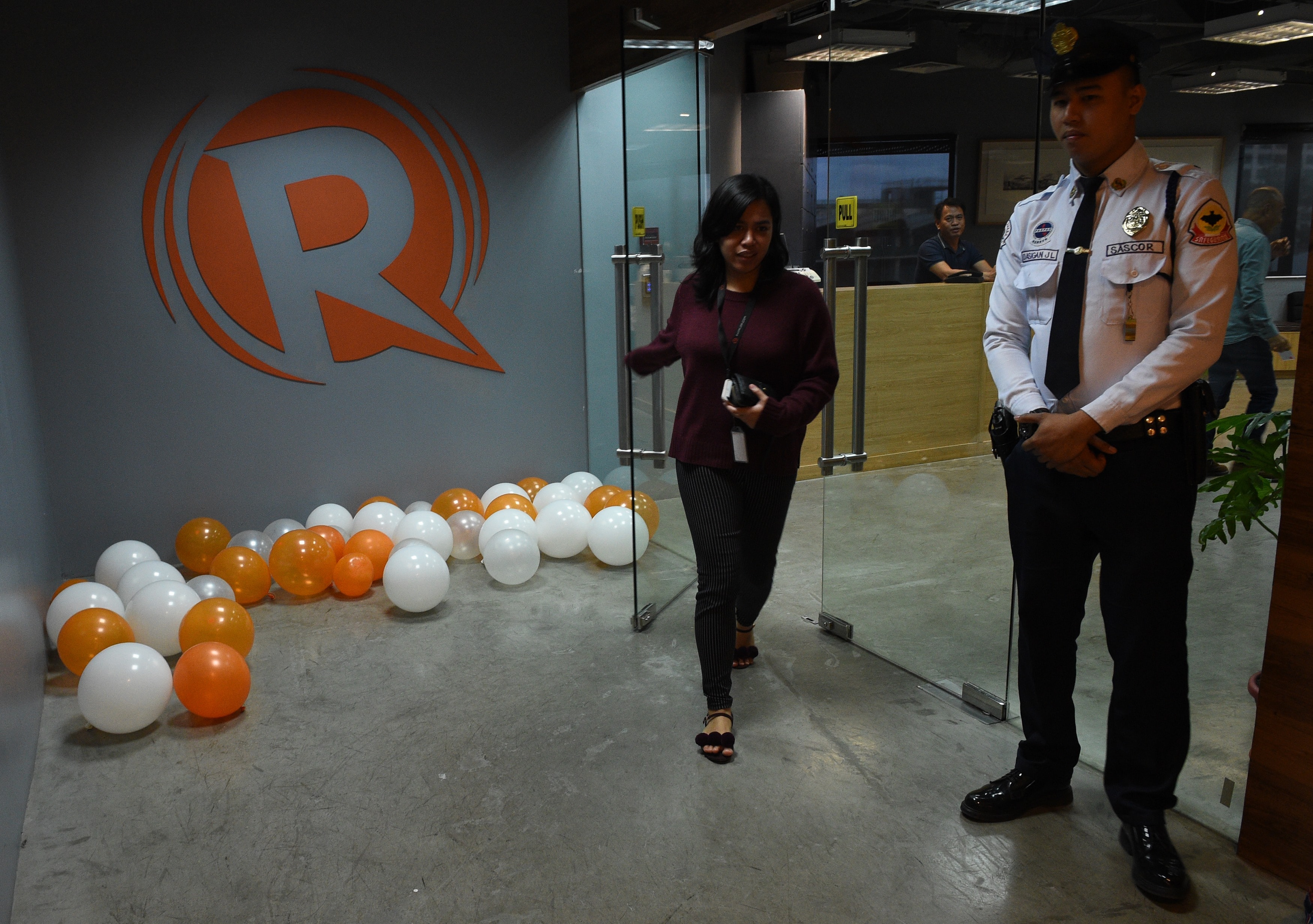 A Rappler employee heads out of their editorial office in Manila on January 15, 2018, after the news site's operating license was revoked, TED ALJIBE/AFP/Getty Images