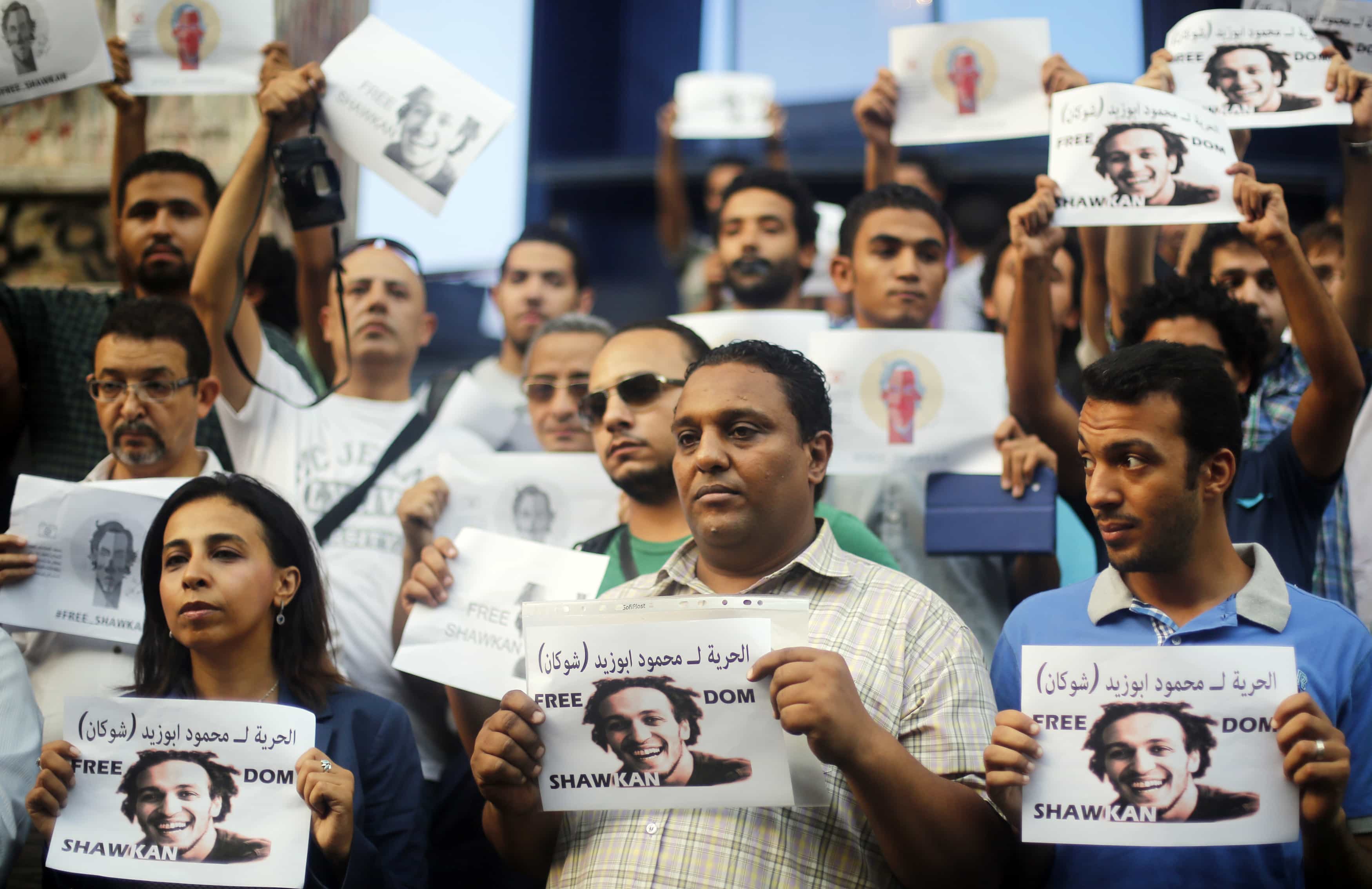 Egyptian photojournalists hold up placards as they take part in a silent protest against the detention of fellow photojournalist Abou Zeid, in Cairo, July 12, 2014, REUTERS/Amr Abdallah Dalsh