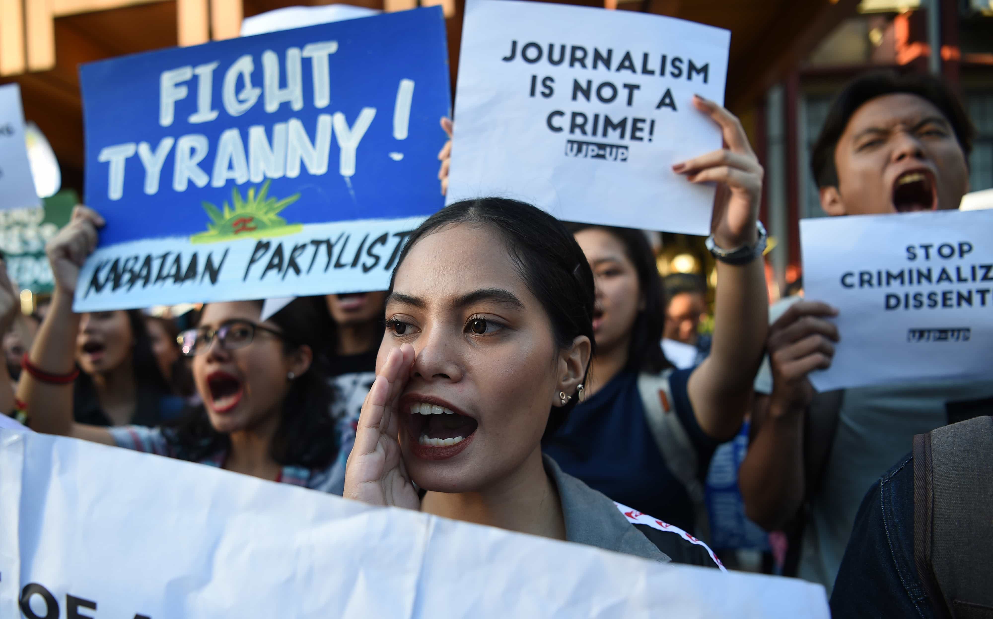 Students hold placards as they shout slogans during a protest at the state university grounds in Manila on February 14, 2019, in support of CEO of Rappler, Maria Ressa, who was arrested a day earlier for cyber libel case, TED ALJIBE/AFP/Getty Images