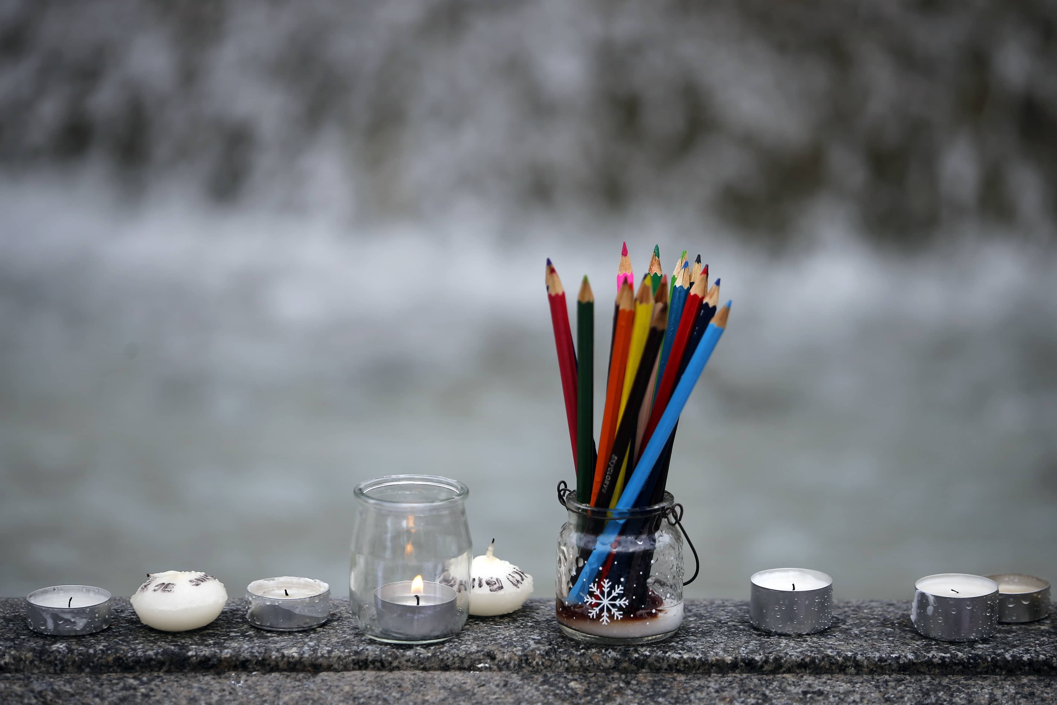 Pencils, representing free expression, are seen near candles as people gather to pay tribute to victims of the Charlie Hebdo attacks (Nantes, January 2015), REUTERS/Stephane Mahe