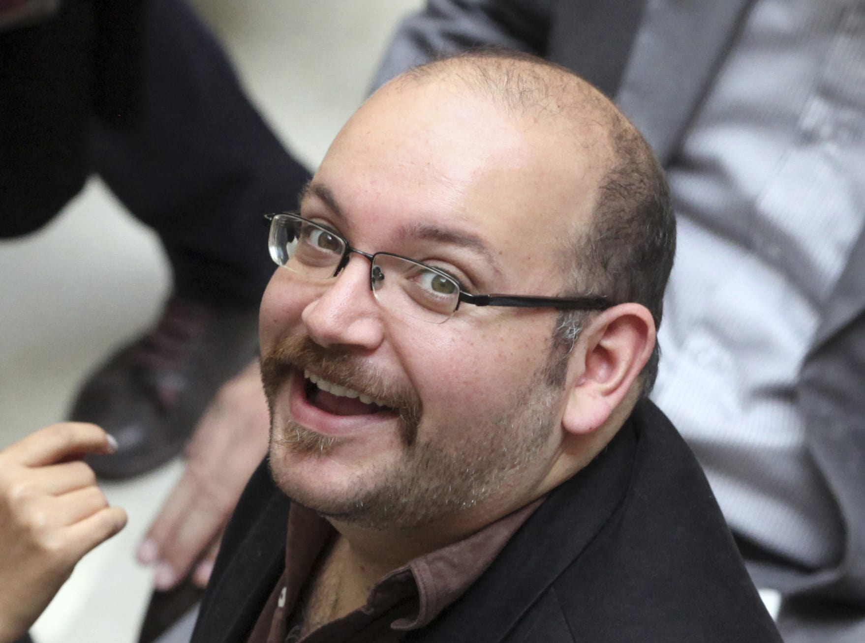 In this photo April 11, 2013 file photo, Jason Rezaian, an Iranian-American correspondent for the Washington Post, smiles as he attends a presidential campaign of President Hassan Rouhani in Tehran, Iran, AP Photo/Vahid Salemi, File