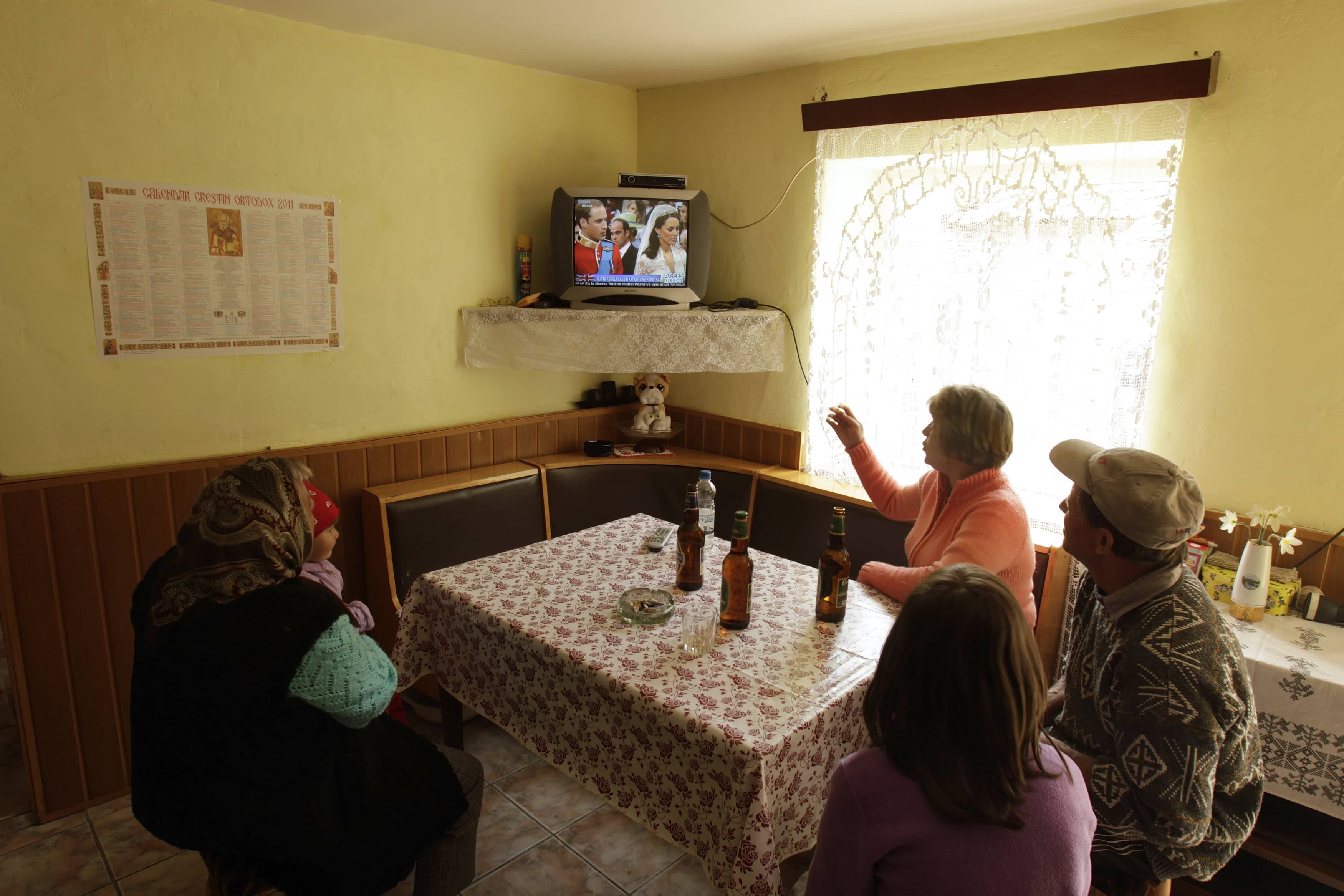 A family watches the royal wedding on television in the small Transylvanian village of Viscri, 29 April 2011., REUTERS/Bogdan Cristel