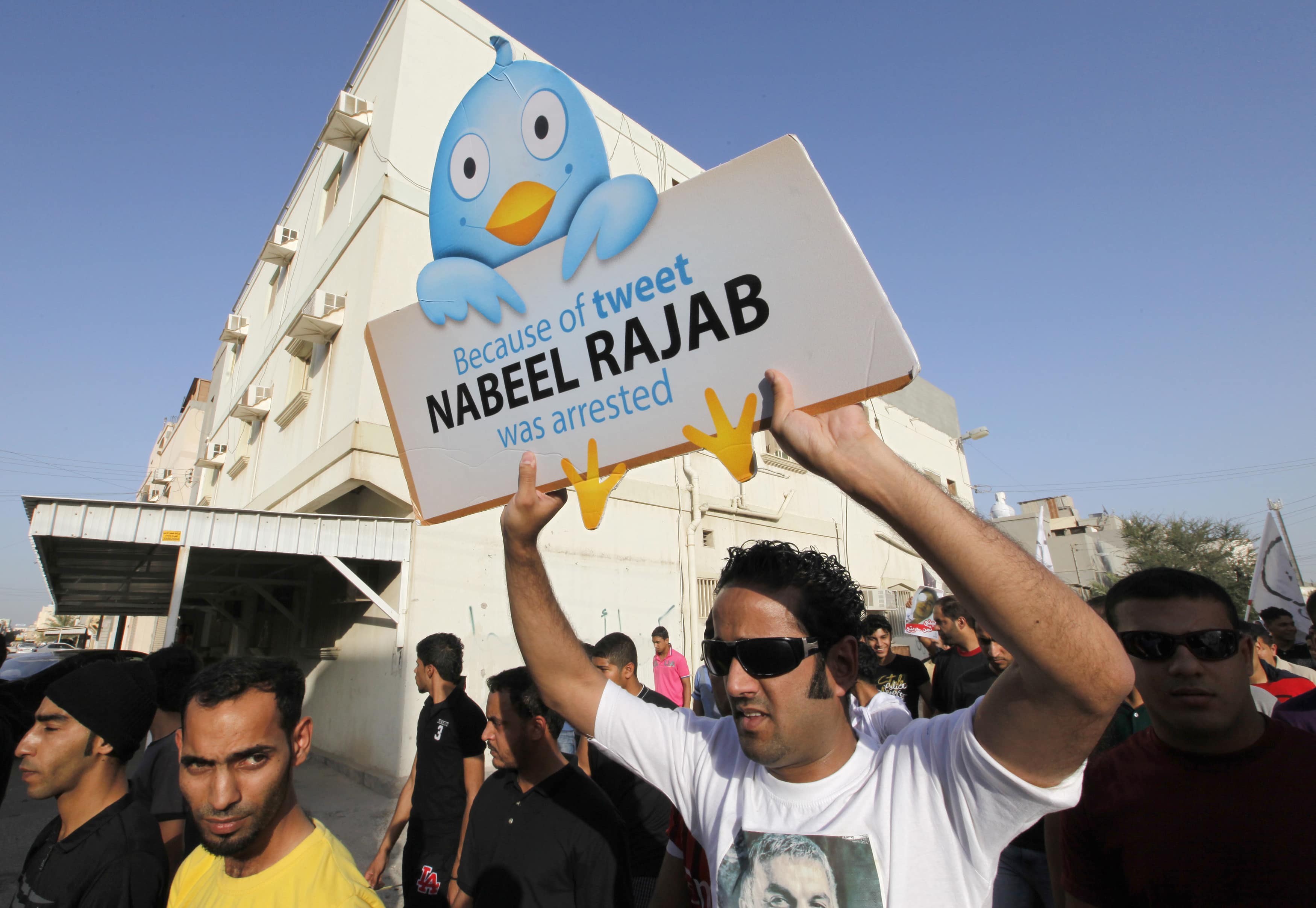 Bahraini rights activist Said Yousif Al Muhafdah carries a placard during a protest calling for the release of jailed anti-government protesters, REUTERS/Hamad I Mohammed