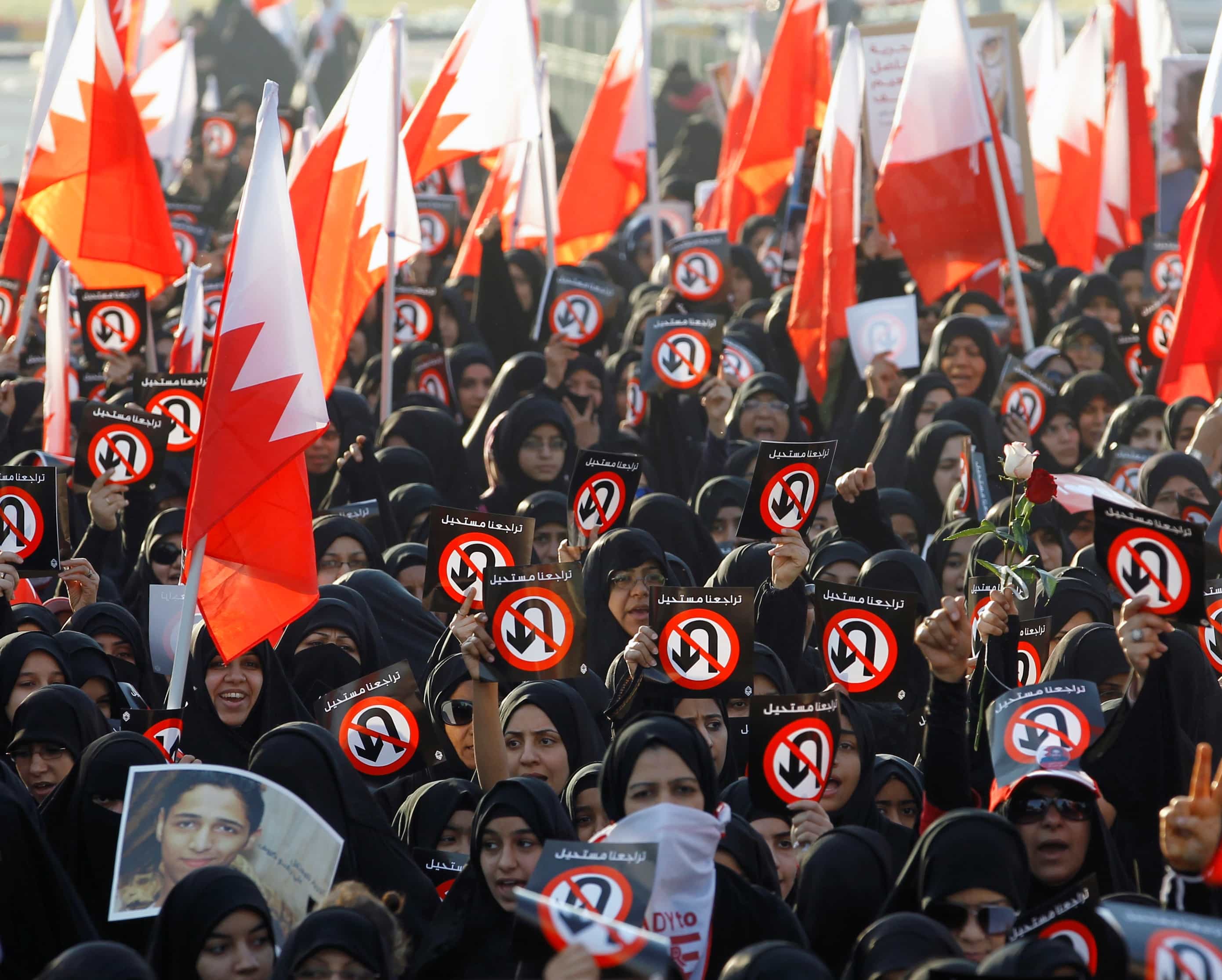 Protesters hold banners with sign meaning "No Returning Back" and hold Bahraini flags as they participate in a rally organised by Bahrain's main opposition society Al Wefaq on February 6, 2013, REUTERS/Hamad I Mohammed