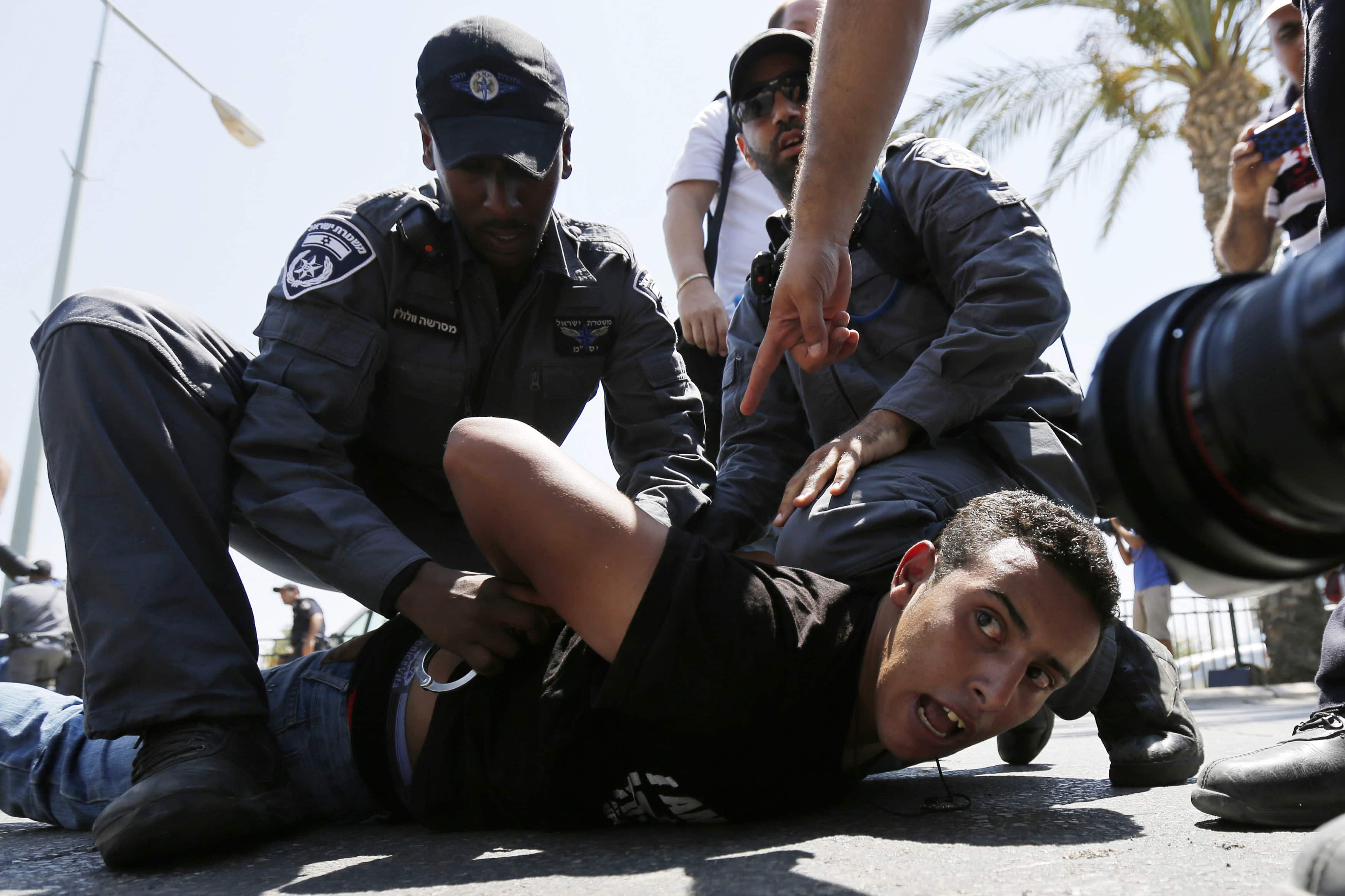 Israeli policemen detain a protester during a demonstration in the southern Israeli city of Beersheba on 15 July 2013, REUTERS/Amir Cohen