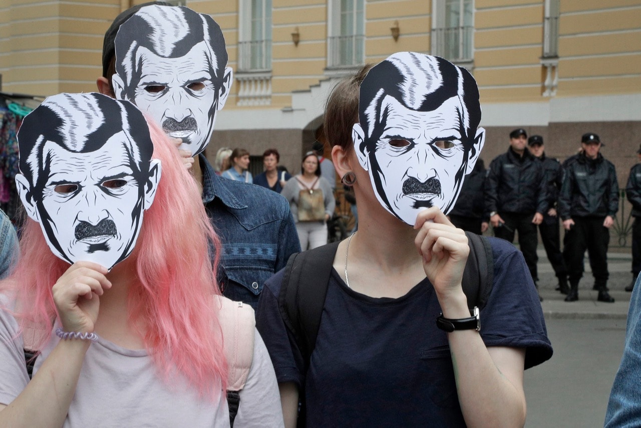 Watched by police people wear face masks depicting the Big Brother character from George Orwell's novel Nineteen Eighty-Four, during a rally 'For freedom on the Internet', in St. Petersburg, Russia, 16 July 2017 , AP Photo/Dmitri Lovetsky