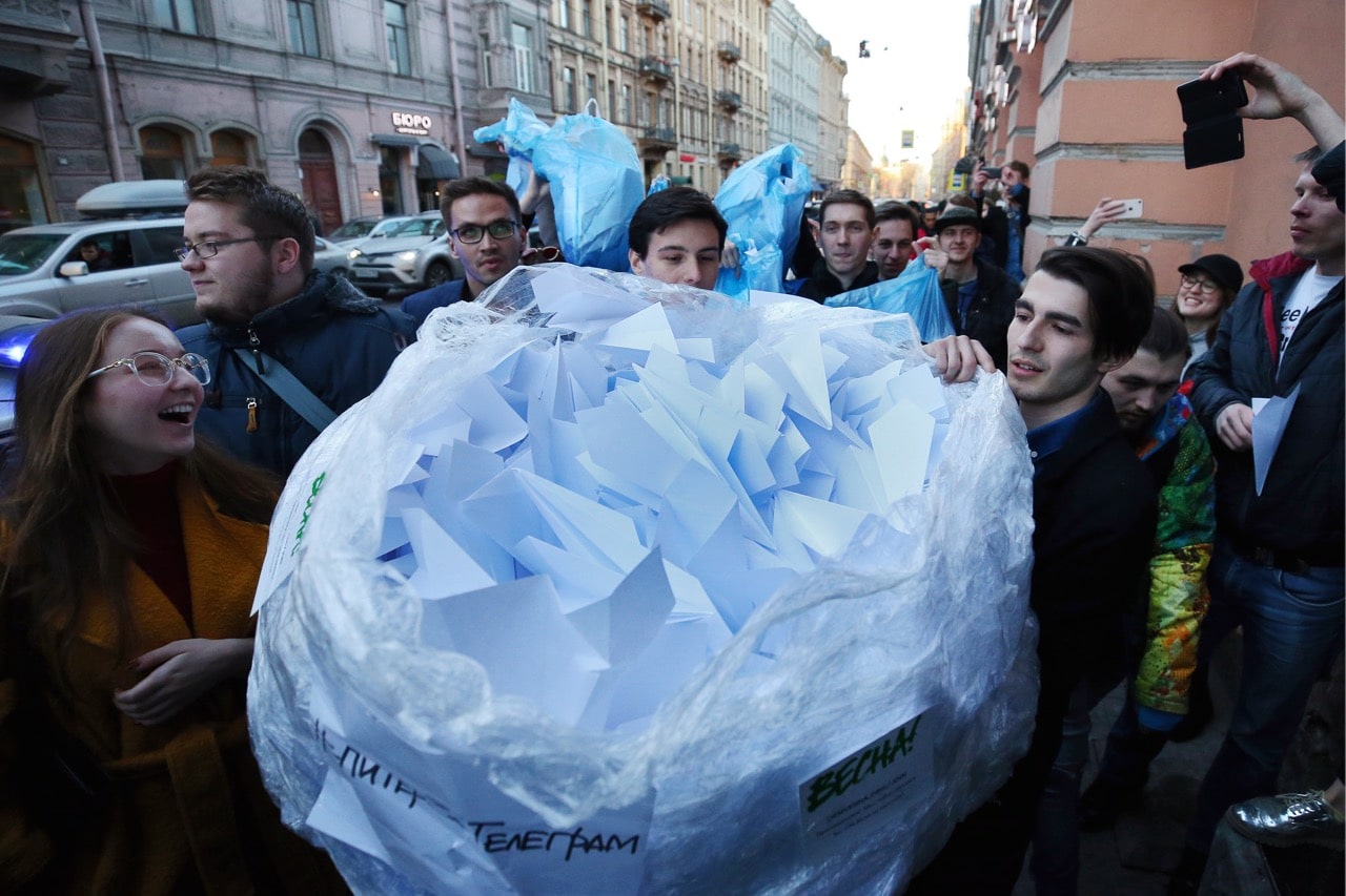 Participants in a flashmob bring a bag of paper planes to the St Petersburg office of Russia's Federal Service for Supervision of Communications, Information Technology and Mass Media (Roskomnadzor) in response to the blocking of the Telegram messaging app, 13 April 2018, Peter KovalevTASS via Getty Images