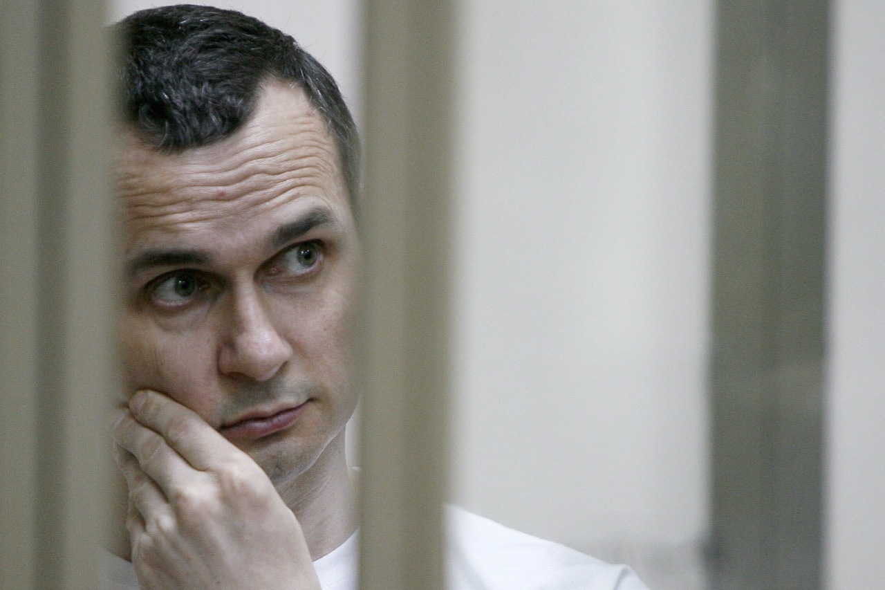 Ukrainian film director Oleg Sentsov stands inside a defendants' cage during a hearing at a military court in the city of Rostov-on-Don, Russia, 21 July 2015, SERGEI VENYAVSKY/AFP/Getty Images